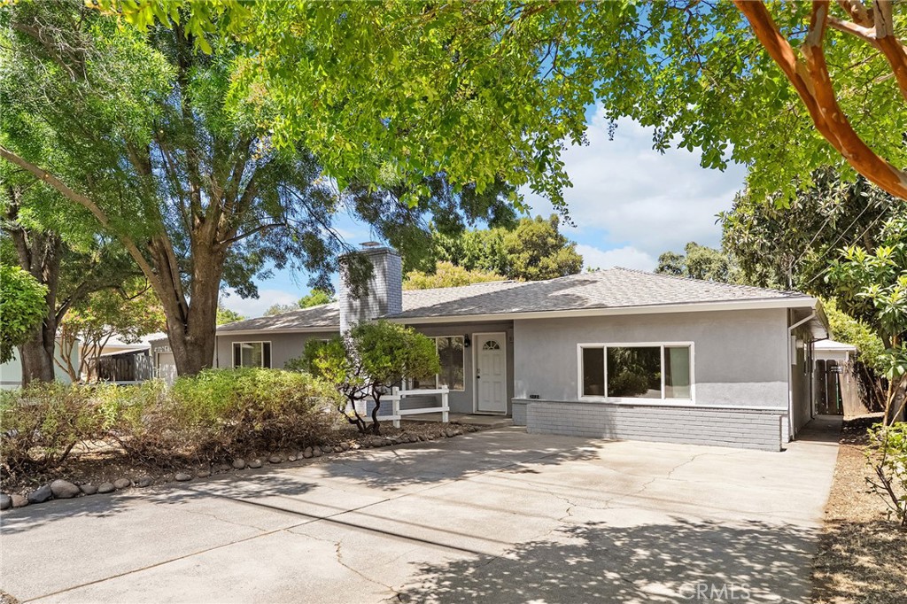 This spacious and thoughtfully updated 4-bedroom, 3-bathroom home offers a fantastic layout and a prime location near schools, parks, In Motion Fitness, and shopping. The split floorplan provides privacy and function, with the primary suite on one side of the home and three additional bedrooms and two updated bathrooms on the other. Step inside to find a spacious living room featuring a cozy wood-burning insert fireplace—perfect for relaxing evenings. The remodeled kitchen features granite countertops, custom tile backsplash, beautiful cabinetry, stainless steel appliances, modern lighting, and breakfast bar seating. The primary suite offers comfort and style, complete with a beautifully remodeled en-suite bathroom showcasing a glass-enclosed shower with tile surround, a double-sink vanity, and unique cedar panel ceilings for a warm, elevated touch. Additional features throughout include newer laminate flooring, double-pane windows, arched doorways, ceiling fans, recessed lighting, and stylish sliding barn doors that add charm and functionality. Outside, the large 0.32-acre lot offers plenty of parking and an expansive backyard that’s ready for your imagination. With room for a pool, garden beds, play area, or all of the above, the possibilities are endless!