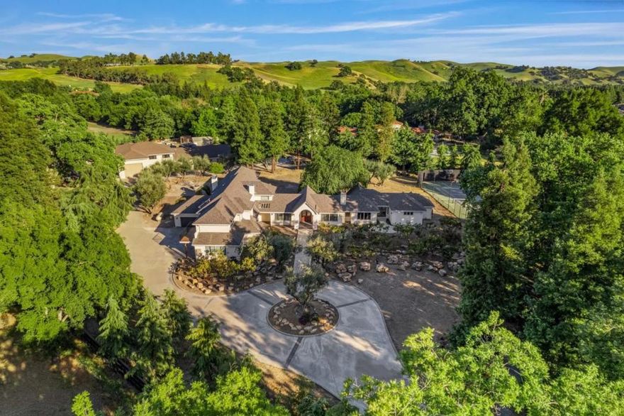 This grand luxury gated estate was demolished to the studs and completely rebuilt with top-tier materials on 5.17acres flat lot. Just 3 miles from Blackhawk Plaza. The 7,204 sq ft main residence features 2 master suites with large walk-in closets, extensive millwork, custom cabinetry, plantation shutters, crown moulding, executive office, and a 6-car garage. Upgrades include brand new roof, stucco, wool insulation, engineered flooring, whole-house rewired with SPAN electrical panels, 8 HVAC systems (2 dual-zone). Additional amenities include an ~800 sq ft 1-bed/1-bath ADU, a 6,100 sqft workshop/showroom with 30-car capacity and RV drive-thru bay, 12 water tanks, private well, tennis court, bocce ball court, seasonal creek, and 100+ year-old oak trees. Over 2M of Remodel and upgrades. Easy access to top-rated SRVUSD schools, freeways, and downtown.