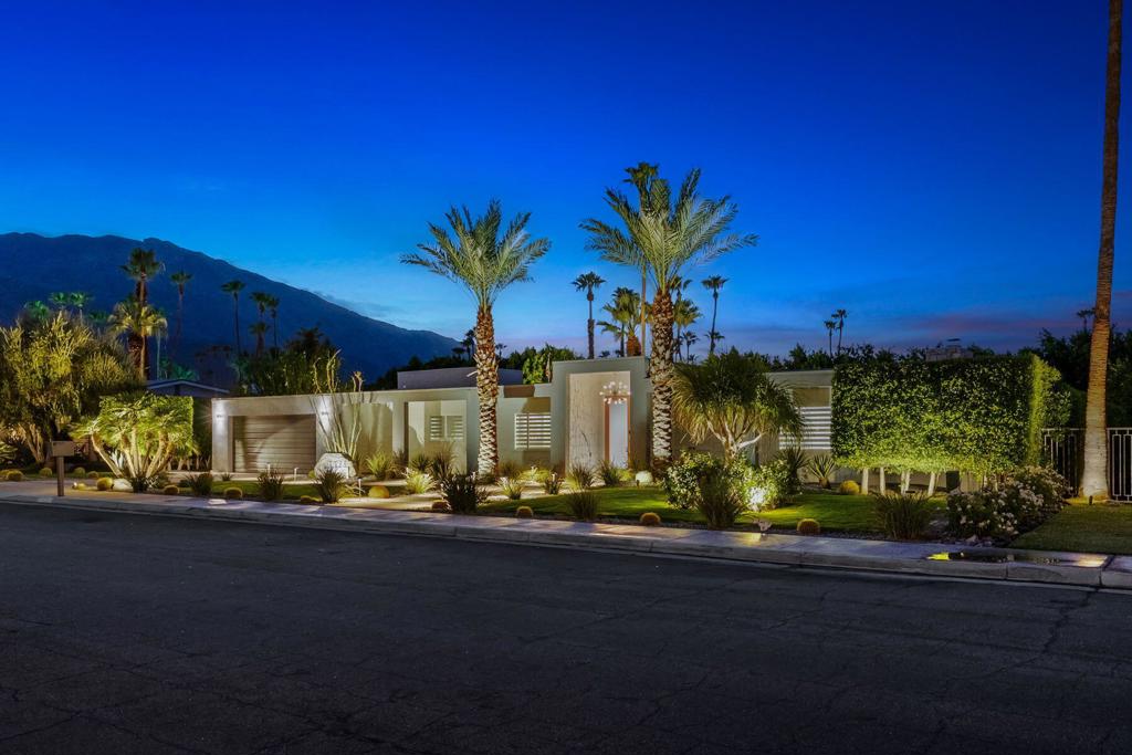 Nestled in the prestigious Indian Canyons enclave, this property marries iconic Palm Springs style with substantial energy savings and mountain‑view outdoor living. Set on a generous 0.25‑acre lot, this meticulously renovated residence spans approximately 3450 ft. with 4 bedrooms, 3 baths and an outdoor shower. Enter through the double-door foyer into spacious open living areas with beamed ceilings and floor to ceiling glass walls, a massive fireplace, a formal dining room, open concept kitchen, a well-appointed wet bar, and generously sized bedrooms. Featuring a luxurious primary suite with a poolside sitting room / office boasting a dual side fireplace while laying in bed or cozying up to a movie in the sitting room. With a dream walk-in closet outfitted with the highest qualities that continue into the primary bath, that has all the bells and whistles. This backyard paradise features a sparkling pool and spa, well appointed gathering areas and retractable awnings for those hot summer days. The serenity here is framed by mountain views and spacious patios that offer gorgeous sunsets. Whether you're looking for your dream Palm Springs paradise, or high-end buyer, the home's grand scale, lush outdoor setting, and solar‑powered efficiency make it a rare find.
