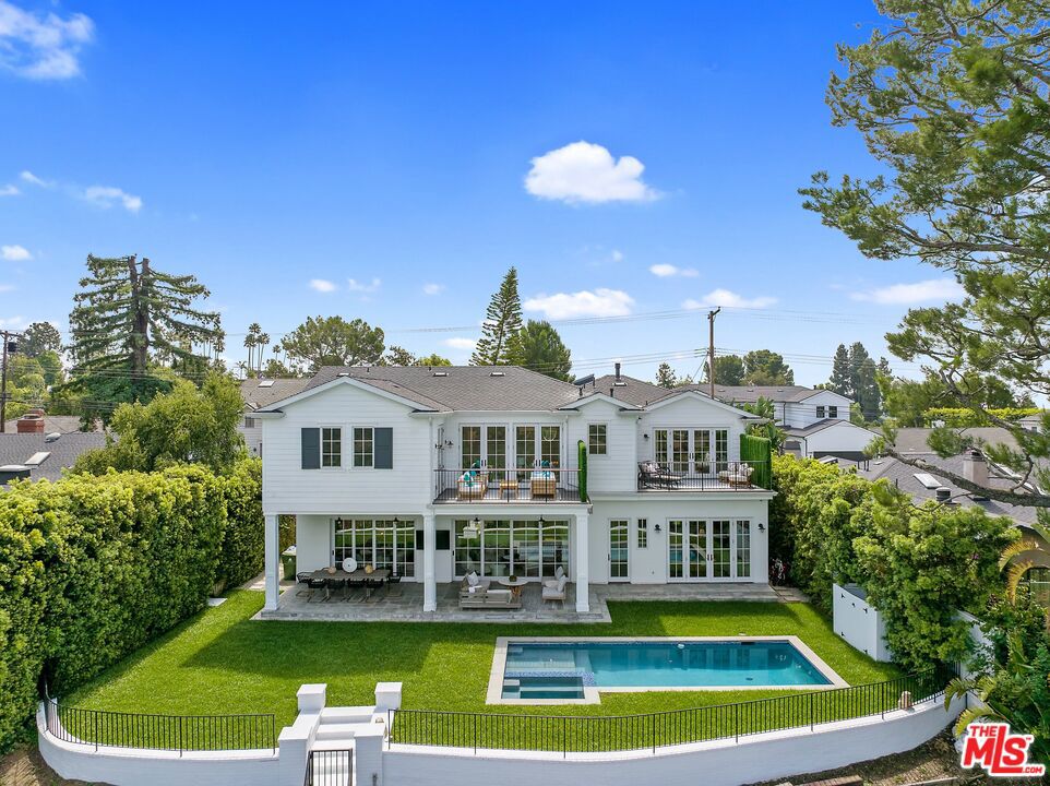 Introducing this remarkable Contemporary Cozy Cape Cod home on a charming Bel Air walk street. This spacious property features 6 bedrooms, all en-suite, with 4 bedrooms & Den upstairs + 2 Bedrooms downstairs, providing ample space for comfortable living. With a generous 4912 square feet of living space on a 21K+ square foot lot, there's plenty of room to spread out and enjoy living, work, and play in spaces that seamlessly blend together. Inside, the home boasts a game room with a 5 speaker surround sound system, HD projector, and bar, making it an ideal space for entertaining. Step outside to soak in the breathtaking views from the deck or unwind under the covered patio, perfect for a meditative moment or hosting outdoor gatherings. The backyard is a true oasis, complete with a refreshing pool and a basketball/sport court, offering endless opportunities for recreation & relaxation. The Primary Suite is its own wing, includes private view balcony, spacious His & Hers walk-in closets, and a primary bath w/steam shower. The property also features a direct entry garage and an ample laundry room for added convenience. Located in a prime Bel Air location, this property presents a rare chance to own a piece of tranquility in the heart of LA. Don't miss out on the chance to make this remarkable property your new home. Schedule a tour today and experience the epitome of comfortable and stylish living in the heart of Bel Air.