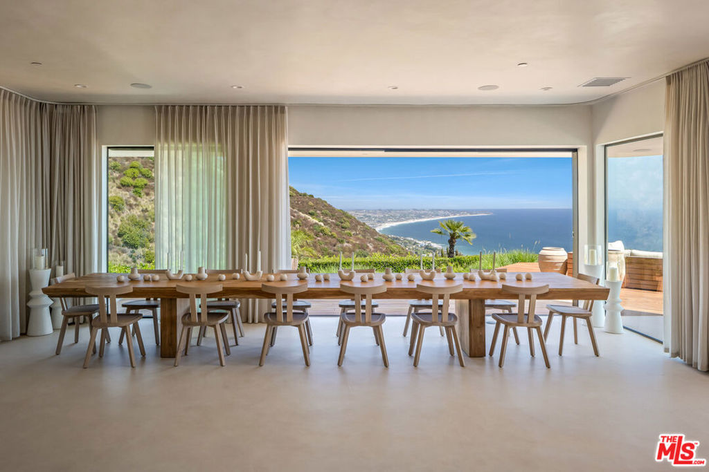 Perched regally atop one of Malibu's most secluded blufftop peninsulas, this newly reimagined, fully furnished estate offers a sweeping coastal spectacle from Point Dume across tranquil Point Mugu. Spanning over 9,000 square feet of exquisitely appointed living space - including 6 bedrooms and 6 baths - this residence is a harmonious convergence of artistic vision and architectural finesse. Inside, a serene palette of warm white tones and exotic hardwoods suffuses each room with refined simplicity. Versatile natural light cascades in through expansive windows, turning every interior into a living tableau of ocean and mountain panoramas. Luxe amenities elevate daily life: lounge by the shimmering pool, unwind in the infrared or Swedish sauna, or plunge into the refrigerated cold tub. Dine al fresco with ease from a wood-burning or gas pizza oven beneath the stars, and gather around fire pits to bask in incomparable sunset views. Entertainment is uncompromised: from a fully immersive home theater to a vibrant game room - complete with ping-pong, backgammon, and poker - every joy is steps from your poolside sanctuary. The entire upper floor, a 4,000-square-foot primary suite, makes a majestic retreat. With a spa-worthy ensuite featuring a steam shower, hair-and-makeup gallery, and panoramic ocean views, it's framed by a wraparound deck outfitted for sunrise lounging beside the fire. As dusk falls, retreat to the adjacent closet lounge with a favorite tipple in hand, or settle into the cozy pajama lounge for family movie nights. A gym with sweeping ocean vistas and a panoramic glass-enclosed office complete this sovereign sanctuary. Set behind gated entry, this estate is defined by its utter privacy - no neighbors within a five-iron's length - it remains moments from local favorites like Vintage Market, Malibu Brew Pub, Starbucks, and the pristine beaches.