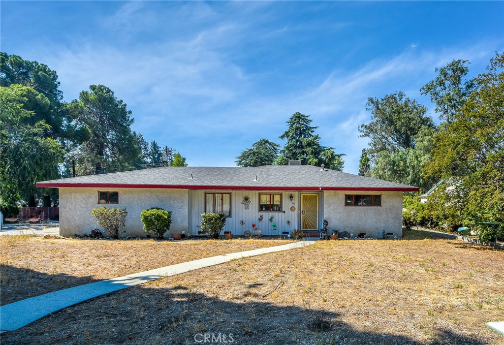 This spacious 4 bedroom 2 bath corner lot home has a lot to offer for the price; just over a 1/4 acre, and priced under 400,000! Great affordability for those who are handy or investors looking for fix and flip opportunities! Block wall fencing, gated RV access, newer appliances, ceiling fans, panel doors, new lateral to sewer main, 200 AMP panel, laminate wood flooring in kitchen and entry and newer vanity and fixtures in primary bathroom are some of the improvements already in place.
