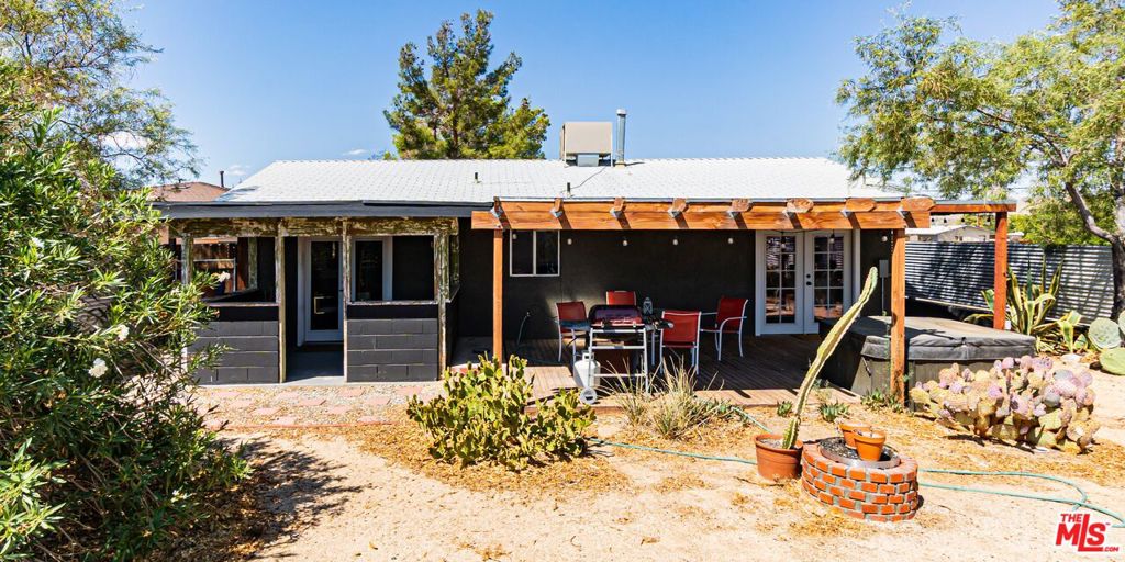 Beautifully Upgraded Home in Downtown Joshua Tree! This home features a modern open-concept layout & has shaved laminate flooring & many other upgrades throughout. Spacious living room. Dining area w/ pendant lighting. Kitchen w/ dine-in bar. Two generously-sized bedroom w/ an updated bathroom. Fully gated backyard w/ covered patio & hot tub - perfect for entertaining! Mature trees & cacti enhance the beauty of the lot. 2 car garage w/ gated driveway. Just minutes from Joshua Tree National Park entrance & walking distance to the village's galleries, shops, & restaurants. An ideal weekend getaway, starter home, or short-term rental!