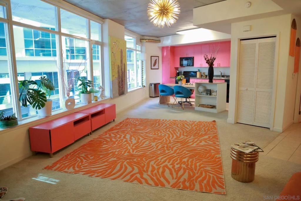 Vibrant Downtown Living at 1080 Park Blvd, Unit 214 Welcome to your dream rental in the heart of San Diego! This stylish and modern unit in the sought-after Smart Corner building offers an urban oasis with bold personality and unbeatable convenience. Interior Highlights: • Spacious, open-concept layout with floor-to-ceiling windows that flood the space with natural light. • Bold, vibrant design featuring a chic gallery wall, neon “Stay Sweet” sign, and an orange zebra-print area rug that adds flair to the living room. • A fully-equipped kitchen with sleek black appliances, ample cabinet space, and trendy pink cabinetry complemented by a versatile workspace island. • Stylish and comfortable living spaces designed to impress and inspire. Amenities: • One reserved underground garage parking spot included. • Rooftop deck with breathtaking city views, lounge areas, and a hot tub. • On-site fitness center for your convenience. • Prime location near the trolley, providing seamless access to the best of San Diego dining, shopping, and entertainment. Rental Details: • Rent: $2,800 per month • Deposit: $800 • 1 bedroom | 1 bathroom This one-of-a-kind unit is perfect for anyone looking for a vibrant and creative space in the heart of Downtown San Diego. Don’t miss out—make Unit 214 your new home!