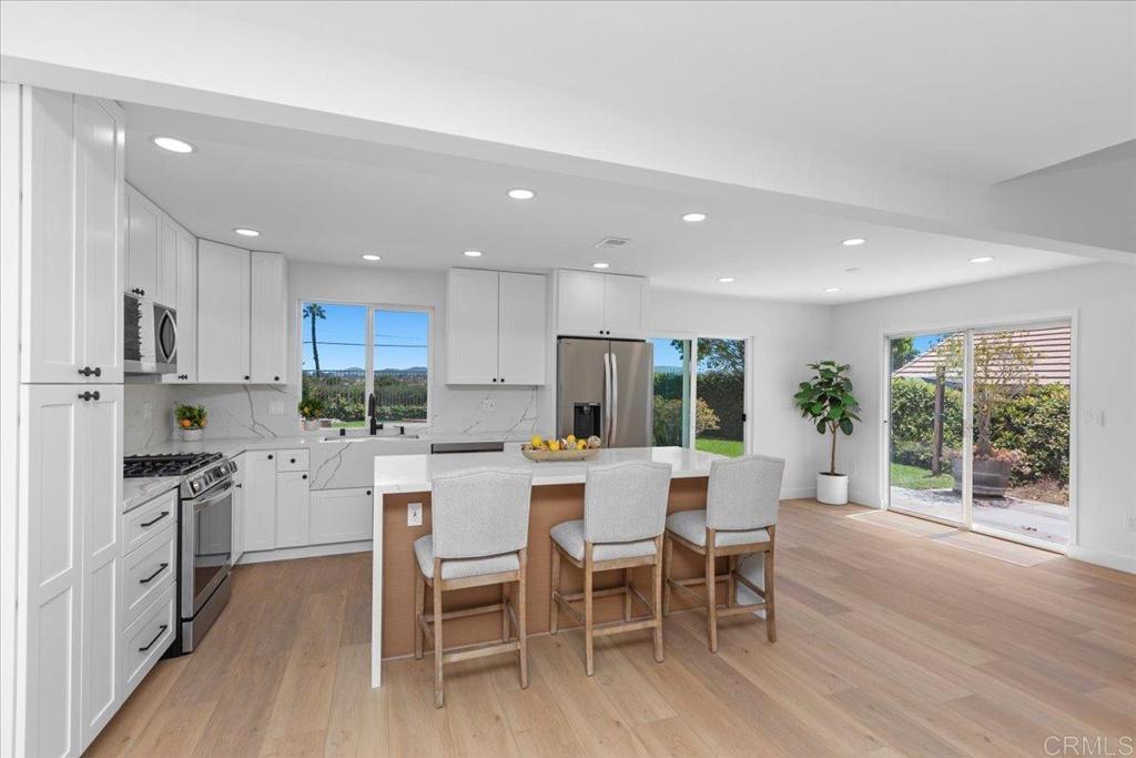 This beautifully updated 3 bedroom + loft home is located in a desirable gated community in Vista. This turnkey property features a modern open-concept layout, vaulted ceilings, and high-end designer finishes throughout. The main level offers a living room with fireplace, dining area, and a sleek, upgraded kitchen that looks out to the backyard and open space—perfect for entertaining and filled with natural light. A convenient half bath completes the downstairs floor plan. Upstairs, a flexible loft adds space for a home office, media area, or playroom. The large primary suite includes a beautifully upgraded ensuite bathroom, while two additional bedrooms share a stylishly renovated hall bathroom. Enjoy gated security, a community pool, and a prime location near shopping, dining, top schools, and commuter routes.