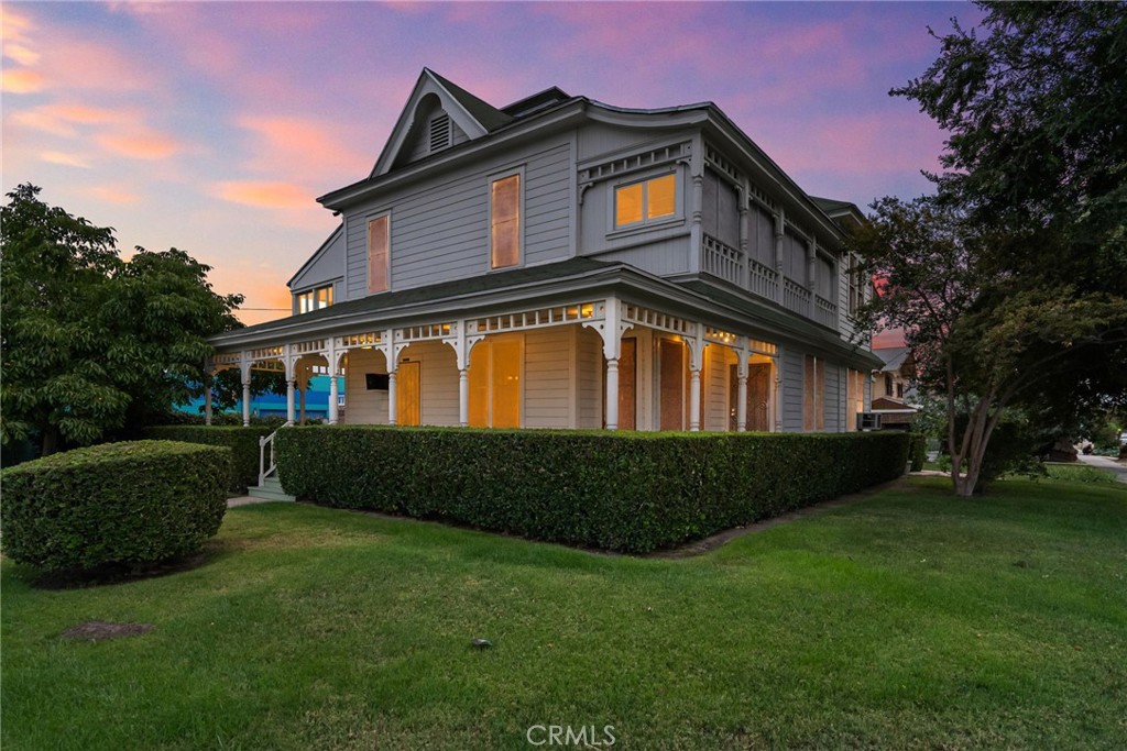 Constructed in 1890, this distinguished Queen Anne Victorian residence still presents with the original detail, elegance, and beauty that it did at its inception. The first floor is defined by spacious common areas with tall ceilings, natural light, and warm woods. All of these aspects coalesce to sing the history of the home in every space. A generously proportioned dining room with soaring ceilings. An inviting living room with the original hardwood floors and period-correct fireplace with a colorful tiled surround, a handsome wood mantel, and a classic overmantel mirror. A full bathroom that is both functional and charming. An office illuminated by a bank of large windows. The kitchen exudes simplicity, functionality, and aligns seamlessly with the home’s aesthetic. Upstairs, the central landing opens to three secondary bedrooms and the primary suite. The primary suite offers ample space, light, and an enclosed porch area that could be a closet or ensuite office. A recently remodeled full bath serves the second floor with aplomb. Outside, the backyard is a private affair, nestled into the junction of the workshop and the primary home and bordered by mature trees. Various garden vignettes make for an outstanding place to relax or entertain. On the opposing side of the breezeway from the primary house is the workshop in laundry area. Currently in use as a laundry room and workshop, this space could be converted to an ADU with its own entrance. Current zoning allows for residential or commercial use (CG-1), effectively increasing the opportunities for the next owner of this architecturally significant residence.