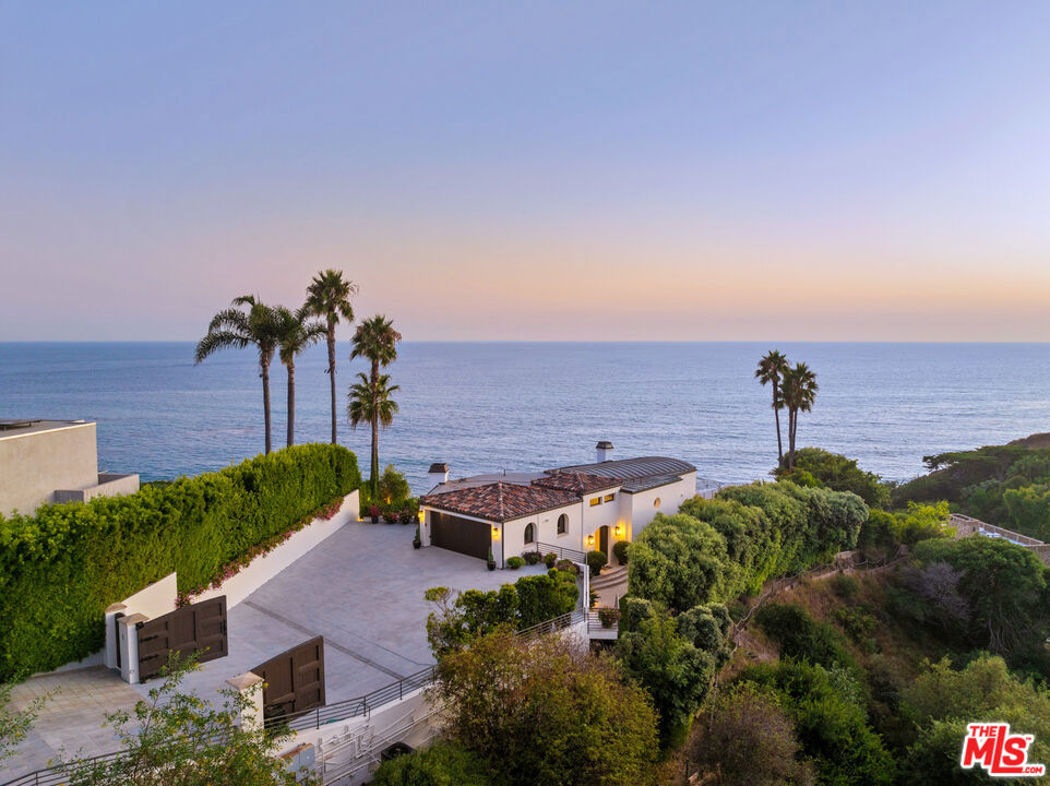 Discover the epitome of coastal luxury with this architectural masterpiece situated on the prestigious Encinal Bluffs. Spanning over 4,500 square feet on a generous 2-acre lot, this stunning estate offers panoramic views from Point Dume to the Channel Islands, providing an unparalleled living experience.**Key Features:**- **Expansive Living Space:** The property boasts 4 spacious bedrooms and 4.5 luxurious bathrooms, designed with meticulous attention to detail.- **Master Suite Retreat:** The entire upper floor is dedicated to an opulent master suite featuring a grand bedroom, a lavish bathroom with steam and rain shower, double vanity, and a large bathtub perfect for sunset views. The suite also includes dressing rooms and a private terrace overlooking the ocean.- **Gourmet Kitchen:** The custom kitchen is equipped with top-of-the-line Miele stainless appliances, including 2 ovens, a steam oven, a 6-burner ceramic cooktop, a gas wok, a coffee maker with a cup warmer, a sub-zero refrigerator/freezer, a dishwasher, and a wine cooler, making it a chef's dream.- **Elegant Interiors:** Hardwood floors and high beamed ceilings accentuate the family, living, dining areas, and master bedroom, creating a warm and inviting atmosphere.- **Beachfront Cabana:** A charming cabana with bi-folding doors that opens directly to the ocean, perfect for entertaining or relaxing by the beach.- **Private Beach Access:** Enjoy direct access to one of Malibu's finest beaches via your private steps, ensuring a secluded and serene beach experience.**Neighborhood Highlights:**- **Prime Location:** Nestled on Encinal Bluffs, this property offers breathtaking views and a tranquil environment.- **Proximity to Amenities:** Close to newly renovated Malibu High School, parks, shopping and dining options in Malibu.- **Exclusive Community:** Encinal Bluffs is known for its privacy and exclusivity, offering an idyllic retreat from the hustle and bustle of city life.This exceptional estate on Encinal Bluffs is more than just a home; it's a lifestyle. Experience the ultimate in beachfront living with this one-of-a-kind property. Contact us today to schedule a private tour and make this dream home your reality.