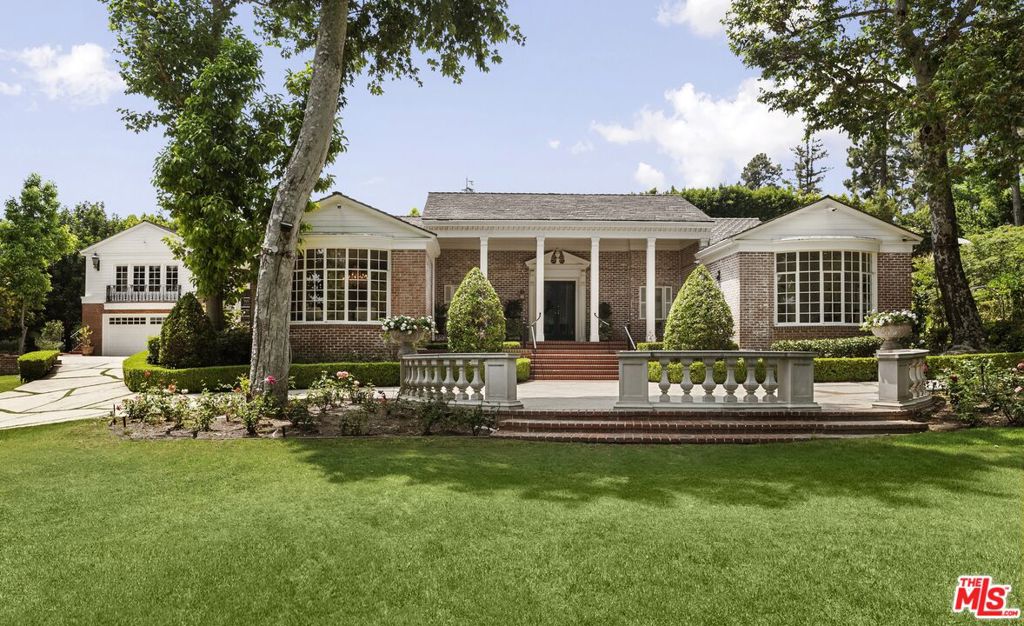 Set behind double gates in one of the most coveted pockets of Beverly Hills - North of Sunset, just behind the iconic Beverly Hills Hotel - this extraordinary estate offers both pedigree and privacy on a rare, nearly one-acre parcel. Designed by Paul R. Williams for Mrs. John Landis, the Colonial Revival home reflects his signature elegance, blending classic proportions with a warm, livable layout that opens effortlessly to the gardens. Flooded with natural light, the interiors feel open and airy, with French doors and expansive windows framing views of brick walkways, a lozenge-shaped pool, and an elegant cabana complete with bath, kitchen, and built-in BBQ. A grand marble entry hints at the refined detailing throughout. Lush gardens, mature trees, and a picturesque gazebo create a series of intimate moments across the estate, offering a sense of escape that feels worlds away. From the wood-paneled dining room with curved bay windows to the inviting breakfast room, every space reflects timeless craftsmanship. In addition to the main residence, the property includes a charming separate guest suite along with two staff rooms - ideal for visitors, a private office, or support staff. A true estate in every sense - majestic yet inviting, private yet perfectly situated - tucked away just moments from the finest restaurants, shops, and cultural landmarks of Beverly Hills, yet offering the serenity of a world apart.