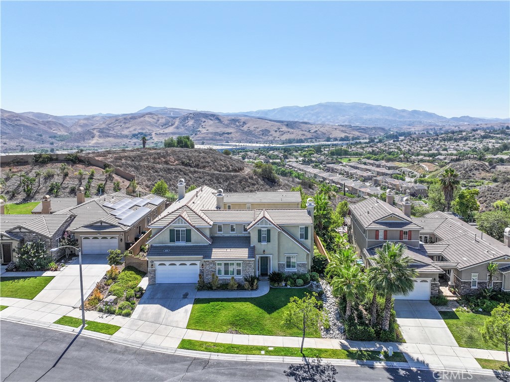 Stunning Executive VIEW home on single loaded street, with No Neighbors behind. Located in the Retreat - the Inland Empire's most prestigious, 24-hour manned, gated community. This home features a Junior Master downstairs with a full bathroom, plus a guest half bathroom. Large open Atrium courtyard to enjoy the star filled summer nights. Perfect for entertaining. Gourmet kitchen with upgraded, top of the line appliances and room to sit 18 people. Oversized family room features raised hearth fireplace. Front and rear stairways. Master suite with balcony spanning the entire rear of the home, with STUNNING panoramic views. 3 more large bedrooms upstairs and 2 more full baths. Pool table size bonus room also upstairs. Large backyard with unobstructed views.