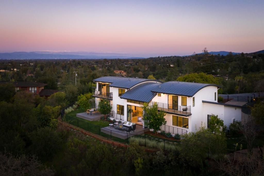 Los Altos Hills contemporary of exceptional quality with sweeping views. Gated, fenced property of approx. 1.09 acres. Luxurious comfort for gracious indoor-outdoor entertaining. Three levels with elevator, open-concept, lots of glass, oak floors. Barrel-vaulted living room opens to entertainers deck and views. Dining room has stacked-stone wall, temp-controlled wine display/storage. Also open to view deck family room/kitchen has wraparound windows, fire feature, dining area, waterfall countertop island, bar seating, custom cabinets, top-of-the-line appliances. Main floor office and en-suite bedroom. Three en-suite bedrooms upstairs with barrel-vault ceilings. Owners suite is private sanctuary with views, views, views. Lower level is entertainment/guest area with home theater, sitting room, wet bar, gym/yoga room, laundry, en-suite guest bedroom. Smart home technology, direct-access two-car garage. Palo Alto Schools. A home of rare tranquility for a lifestyle of harmonious comfort.