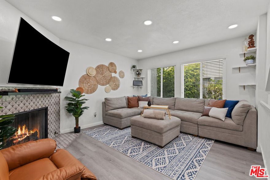 This townhome is conveniently located and offers a spacious, open-concept floor plan designed for functionality. It is an interior end-unit with only one shared wall. Recent updates include laminated flooring, LED lighting, stainless steel appliances, new quartz countertops in both the kitchen and bathroom, renovated laundry room,  a water softening system, nest thermostat, and a smart keyless front door lock. The primary suite has vaulted ceilings, dual closets, and an en-suite bathroom. Upstairs, there is a second bedroom and a full bathroom. The attached two-car garage features storage areas and an adjacent laundry room. A new garage door and opener have been added, and the washer and dryer are included. Common areas provide a garden picnic space and a clubhouse. Rent covers trash removal and gardening services. The complex has an automatic security gate and recent improvements such as updated stucco, paint, and a new roof. The property is situated between Los Angeles and Orange County, offering convenient access to the 110, 91, and 405 freeways, and is close to stores including Vons, Sam's Club, Blink Gym, and various shopping centers. could also be rented furnished.