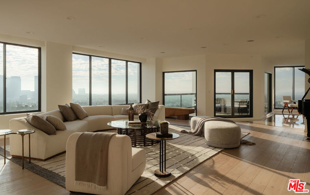 Welcome to the Penthouse at Park Wilshire - A rare opportunity to own one of Los Angeles' most significant high-rise residences. Encompassing over 6,600 square feet of living space, this remarkable Penthouse embodies the essence of refined luxury with 270-degree panoramic views from the ocean to the hills, enjoyed from four expansive terraces. An elegant paneled entry leads to grand living and dining areas flooded with natural light through walls of glass. Soaring ceilings, abundant wall space, and wide-plank white oak floors set an ideal backdrop for art and entertaining. The brand-new chef's kitchen features a Taj Mahal quartzite island and Miele appliances. The serene primary suite spans over 1,800 square feet, with dual glamorous baths, two walk-in closets, a private kitchenette, and a lounge opening to a terrace. A separate wing hosts the junior suite, guest bedroom, and an additional room currently serving as a home office. The media room provides the perfect retreat for film and music enthusiasts. The Park Wilshire's recent renovations offer some of the finest amenities on the Corridor; an elegant lobby, library lounges, pool/spa, and a modern, expansive fitness center. With views stretching from sunrise to sunset, this grand residence truly defines elevated Los Angeles full service living. Don't miss out on the opportunity to own this rare offering, located just minutes from Beverly Hills, Hillcrest Country Club, LACC, Bel Air Country Club, Westwood Village and more.