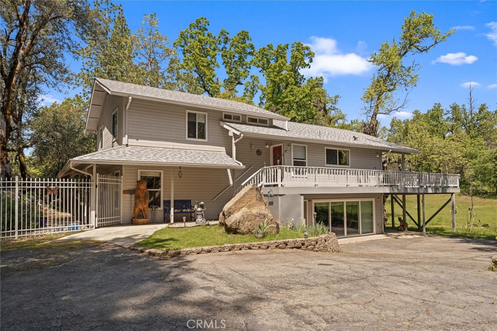 This custom-built home sits on 3.57 usable acres in one of Coarsegold’s most scenic and sought-after areas. Surrounded by majestic oak and pine trees, the property features a picturesque open meadow, perfect for gardening, recreation, or simply enjoying the natural beauty and frequent visits from deer and various wildlife. With approximately 2,820 sq ft, this split-level home offers 5 bedrooms, 2.5 baths, a spacious living room with built-in shelving, formal dining room, and a versatile game room. The kitchen is well-appointed with African granite countertops, updated cabinetry, and a modern cooktop. Natural light floods the interior, and a wood slider beautifully separates the living and dining spaces. The dining area opens to a large deck, ideal for entertaining with views of the meadow. Highlighted include a newer roof (Sept 2024), dual-pane windows, and a detached two-car garage with a newer opener, private well, and back up generator. Schedule your showing today!