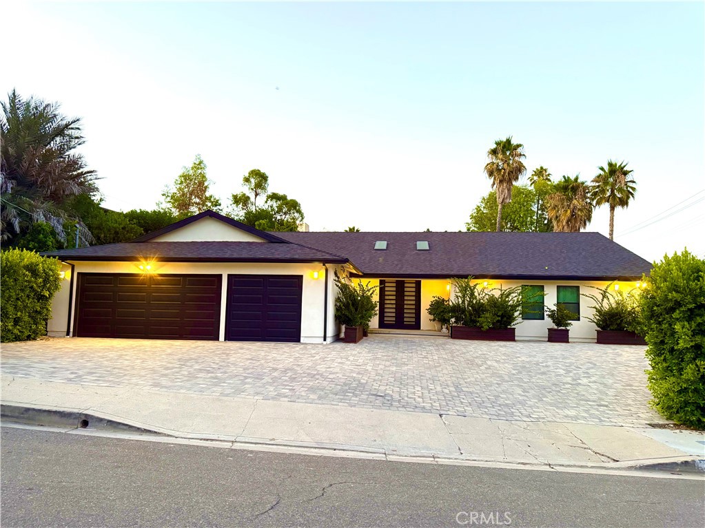 Experience elevated California living in this beautifully reimagined mid-century gem, located in one of Woodland Hills’ most sought-after neighborhoods. Brimming with character and timeless charm, this meticulously maintained residence offers nearly 3,000 square feet of thoughtfully designed living space.
Vaulted beam ceilings and expansive room proportions create an airy, inviting ambiance throughout. The spacious living room and den are anchored by a striking fireplace and are perfect for effortless entertaining.
Retreat to the luxurious primary suite, complete with serene views of the backyard, and a spa-inspired ensuite bath. The home’s layout also features well-appointed guest bedrooms, a formal dining room, a dedicated laundry room, and an impressive three-car garage.
Outside, enjoy your own private oasis with an enclosed front courtyard leading to a lush backyard with a sparkling pool, all situated on a desirable corner lot.