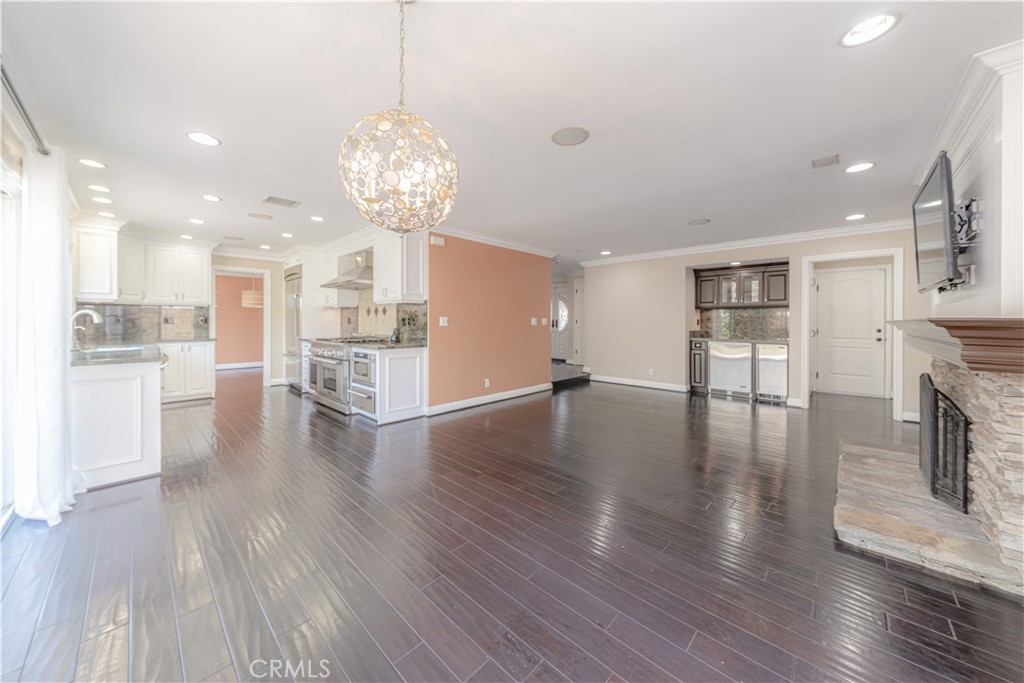Beautifully remodeled two-story 5 bed /3.5 bath home is ready for you to call home. Great curb appeal with paved driveway, 3 car garage, front entrance surrounded by a cozy enclosed patio before entering the home. Inside you’ll find a beautiful stairway with a custom finished railing. The home is wired with a Bose Entertainment sound system inside almost every room and outside and maple hardwood flooring throughout the home. The kitchen features granite countertops, recessed lighting, stainless steel Thermador appliances, 6 burner gas range with griddle, plenty of counter and cabinet space, large windows that allows for lots of natural light. Kitchen opens up to the family room with wet bar and warmed by a fireplace. Bedrooms are all located on the second floor. Master bedroom has a spacious walk-in closet, en-suite bathroom with a large shower lined with subway tiles and pebble tile flooring, water closet and double sinks. Backyard is great for relaxing or entertaining! Equipped with a built in BBQ island for both gas and charcoal, bar seating, retractable patio cover, area for mounted TV and plenty of open space! Located only a few minutes away from Bella Terra, great shopping, restaurants and the 405 fwy and best of all, less than 5 miles to the beach! This home is a must-see!