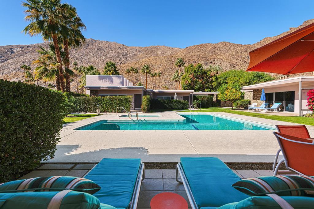 Mid-century design and modern comfort come together beautifully in this two-story condo, created by celebrated architect Herbert Burns. Set in the sought-after Historic Tennis Club neighborhood, the home is just moments from downtown Palm Springs with its lively restaurants, shops, galleries, and nearby hiking trails.Inside, the open-concept layout is ideal for entertaining, with the updated kitchen connecting easily to the dining and living areas. A striking glass-sided staircase leads upstairs to two en-suite bedrooms. The primary suite includes a balcony framing dramatic San Jacinto mountain views, while the guest suite offers European-inspired charm with its rooftop outlooks.Outdoors, a private patio looks onto the sparkling pool and spa, creating the perfect setting to relax or gather with friends. Additional highlights include off-street parking, in-unit laundry, and a complete renovation throughout. Move right in and enjoy Palm Springs living at its finest.