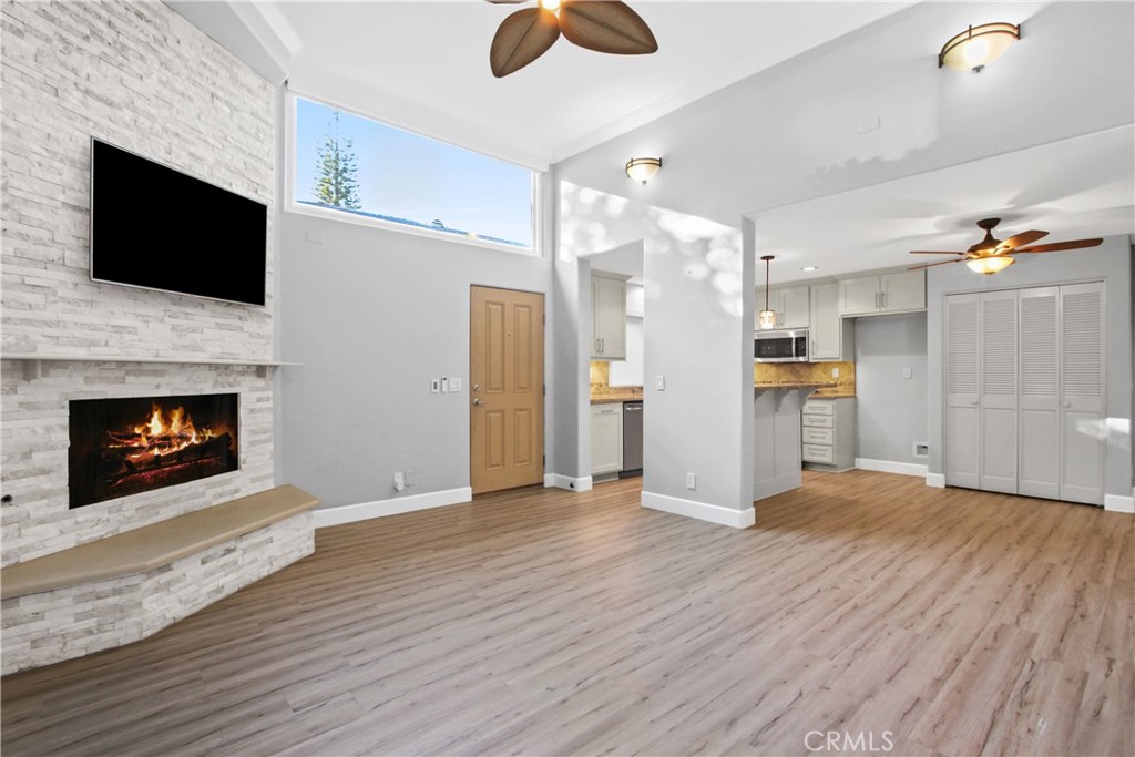 Welcome to this beautifully updated 4-bedroom, 2-bathroom townhome in the highly desirable Vista Del Oro neighborhood of San Pedro. Thoughtfully designed across multiple split levels, this residence blends modern upgrades with inviting spaces, ideal for both everyday living and entertaining. The remodeled kitchen is a true highlight, featuring sparkling stainless-steel appliances, including a high-end freestanding stove, dishwasher, and microwave, granite countertops, under-cabinet lighting, a breakfast bar with pendant lights, and a generous pantry for extra storage. The kitchen flows seamlessly into the dining area and living room, where custom remote-control blinds and a stunning floor-to-ceiling stone fireplace with a handcrafted mantel serve as the centerpiece. TV hookups above the mantel add convenience, while sliding glass doors open to a private shaded patio with direct access to a spacious yard area. The split-level layout offers flexibility and privacy. Just a few steps up, you’ll find two well-sized bedrooms and a remodeled full bathroom with dual sinks. Another short flight leads to a spacious third bedroom with soaring ceilings, perfect for a guest room or an office. At the top, the expansive primary suite provides a true retreat with two walk-in closets, a nautical-inspired accent wall, and sliding glass doors leading to a large private balcony. The remodeled ensuite bathroom features dual sinks, a walk-in shower, and a separate soaking tub with TV hookups, creating a spa-like escape. Additional highlights include an attached two-car garage with 220v hookups for electric vehicles, an interior laundry room, and a recently upgraded electrical panel. The home also offers forced-air heating and air conditioning, dual-pane windows and sliding doors, high-end travertine and vinyl flooring, upscale lighting, ceiling fans throughout, and both hardwired internet and TV hookups in every room. Located in one of San Pedro’s most sought-after neighborhoods, this townhome is just minutes from schools, parks, shopping, and the vibrant San Pedro waterfront. With its spacious layout, thoughtful upgrades, and prime location, this property presents a rare opportunity to enjoy modern comfort in the heart of Vista Del Oro.