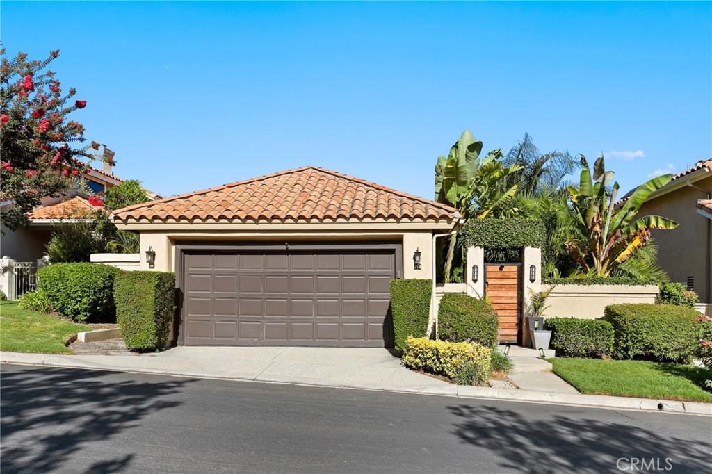 Welcome to 90 Via Candelaria, a truly rare offering in the prestigious gated community of Coto de Caza. One of only 30 single-story ranch-style homes in the entire community, this residence stands out in both exclusivity and design. Ideally located on the northern side of Coto, it is just minutes from the RSM shopping plaza and Coto Sports Park. With no homes in front or behind, the property offers unmatched privacy, serenity, and sweeping 180-degree views of the golf course, lake, Saddleback Mountains, and Caspers Wilderness Park. Evenings are especially magical, with no light pollution and the rare chance to stargaze under open Orange County skies. Inside, the home showcases vaulted ceilings, real hardwood floors, recessed LED lighting, and ceiling fans in every major room. The living area features a custom white tile wall with an electric fireplace, complete with built-in speaker wiring and TV mount. The kitchen is appointed with freshly painted white cabinetry, stainless steel appliances, and new lighting. The primary suite includes sliding doors to the backyard oasis, crown molding, dual sinks, a walk-in shower, and custom lighted bathroom mirrors. Additional enhancements include automated irrigation, custom front gates, upgraded hallway and bathroom lighting, and a pet-friendly backyard fence with a stone path leading directly to the golf course. The highlight of this home is the spectacular backyard, where over $150,000 has been invested in creating a tropical paradise. The landscape features more than 100 palm trees—including 40+ rare species sourced from across California. These palms have been grandfathered in, making this the only property in the Terraces permitted such plantings. Fruit-bearing lemon, orange, lime, and apple trees add to the lush setting. Bamboo fencing, layered palms, and LED flame solar lighting complete the oasis, offering shade by day and ambiance for evening entertaining. Residents of the Terraces enjoy a private pool and spa, while Coto de Caza offers world-class amenities including the Golf & Racquet Club with tennis, pickleball, pools, spas, dining, and fitness center, as well as equestrian facilities, a sports park, and miles of scenic trails. More than a home, 90 Via Candelaria is a rare single-story retreat offering privacy, exclusivity, and natural beauty in the heart of Coto de Caza.