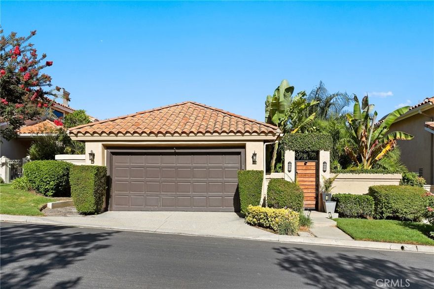 Welcome to 90 Via Candelaria, a truly rare offering in the prestigious gated community of Coto de Caza. One of only 30 single-story ranch-style homes in the entire community, this residence stands out in both exclusivity and design. Ideally located on the northern side of Coto, it is just minutes from the RSM shopping plaza and Coto Sports Park. With no homes in front or behind, the property offers unmatched privacy, serenity, and sweeping 180-degree views of the golf course, lake, Saddleback Mountains, and Caspers Wilderness Park. Evenings are especially magical, with no light pollution and the rare chance to stargaze under open Orange County skies. Inside, the home showcases vaulted ceilings, real hardwood floors, recessed LED lighting, and ceiling fans in every major room. The living area features a custom white tile wall with an electric fireplace, complete with built-in speaker wiring and TV mount. The kitchen is appointed with freshly painted white cabinetry, stainless steel appliances, and new lighting. The primary suite includes sliding doors to the backyard oasis, crown molding, dual sinks, a walk-in shower, and custom lighted bathroom mirrors. Additional enhancements include automated irrigation, custom front gates, upgraded hallway and bathroom lighting, and a pet-friendly backyard fence with a stone path leading directly to the golf course. The highlight of this home is the spectacular backyard, where over $150,000 has been invested in creating a tropical paradise. The landscape features more than 100 palm trees—including 40+ rare species sourced from across California. These palms have been grandfathered in, making this the only property in the Terraces permitted such plantings. Fruit-bearing lemon, orange, lime, and apple trees add to the lush setting. Bamboo fencing, layered palms, and LED flame solar lighting complete the oasis, offering shade by day and ambiance for evening entertaining. Residents of the Terraces enjoy a private pool and spa, while Coto de Caza offers world-class amenities including the Golf & Racquet Club with tennis, pickleball, pools, spas, dining, and fitness center, as well as equestrian facilities, a sports park, and miles of scenic trails. More than a home, 90 Via Candelaria is a rare single-story retreat offering privacy, exclusivity, and natural beauty in the heart of Coto de Caza.