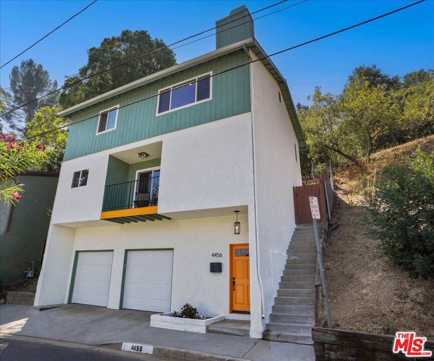 Perched high in the coveted hills of Mt. Washington, this modern hillside gem blends sleek design with natural serenity. Spanning three levels and bathed in light, the open-concept layout features warm planked floors, expansive picture windows, and a sleek fireplace. Balcony with a view off the dining area. Canyon and Treetop views from every level. The renovated kitchen boasts stone countertops, and stainless appliances perfect for both daily living and entertaining. Sliding door opens to 2 private patio terraces ideal for alfresco dining with stunning canyon and mountain views. The Primary Suite is a tranquil retreat, vaulted ceilings where dreams and creativity soar. Also features a walk-in closet and updated bath. Two additional bedrooms offer flexibility for guests, work, or creative space. Outside, enjoy terraced patios, trees and foliage offering privacy and calm. Extras include a guest powder room, central HVAC, laundry area, and 2-car garage with loft storage. Located within the highly sought-after Mt. Washington Elementary boundary, and moments from parks, Jack Smith and other trails, and NELA's vibrant scene.