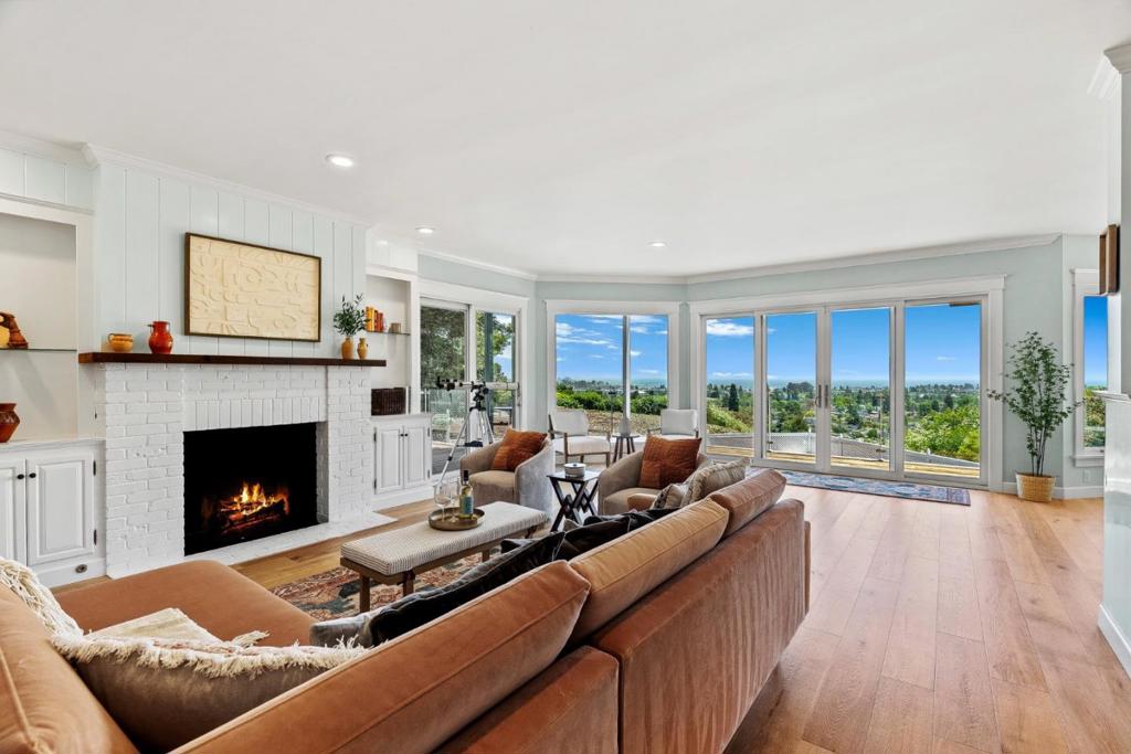 Properties like this don't come up often, especially one that combines a mostly usable lot with expansive ocean & city views. Tucked away from the street, this property offers privacy, mature landscaping, a white sand bocce ball court, & standout curb appeal. Extensively remodeled throughout with a newer roof & solar. The interior features hardwood floors, large picture windows that flood the home with light, & an open-concept living, dining, & kitchen area. The chefs kitchen boasts waterfall Carrera marble countertops & generous space for entertaining. The main level includes two bedrooms, one with an ocean view deck. Upstairs, the private primary suite is a true retreat with sweeping ocean vistas, its own balcony, a spacious walk-in closet, & a luxurious bath featuring quartzite counters, a walk-in shower, & a soaking tub perfectly positioned to take in the views. A large finished basement with a full bath offers flexible use as a home gym (complete with sauna), office, or media/game room. The backyard is an entertainers dream, complete with multiple lounge areas, a swimming pool & hot tub, fire pit, & an outdoor BBQ. All this just steps from Westlake Pond Park, Westlake School, UCSC, & the scenic Pogonip hiking & biking trails plus easy access to downtown & the beach.