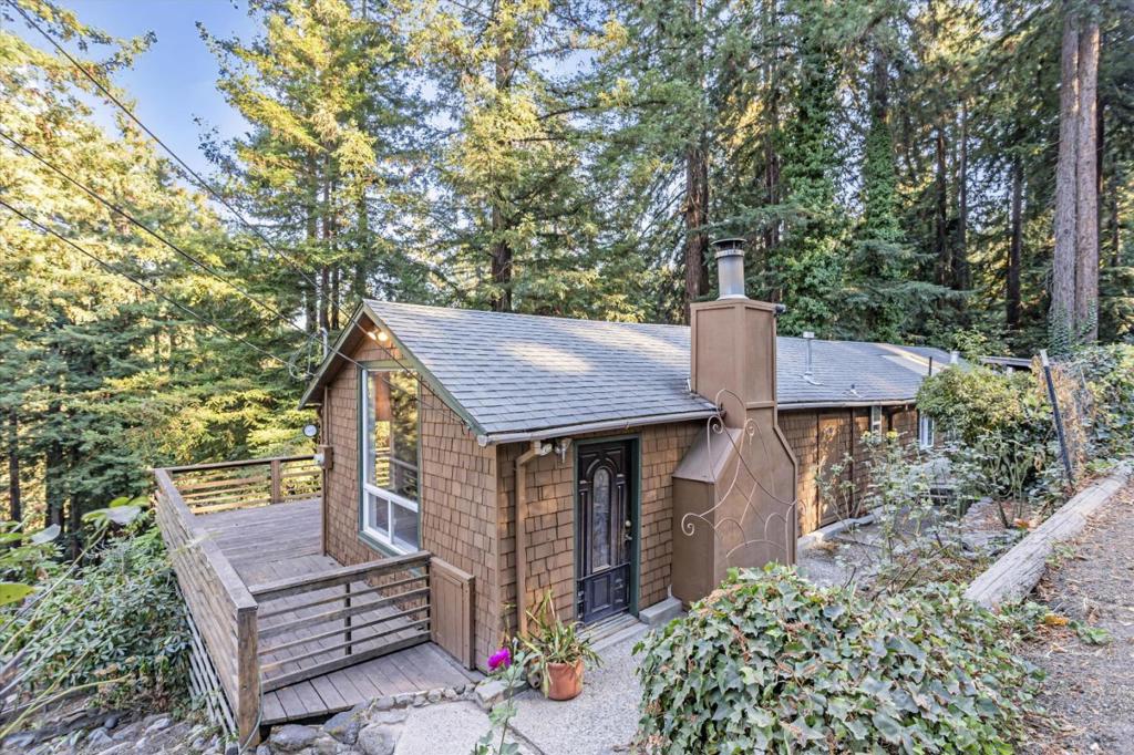 Imagine being surrounded by nature! This vintage charmer is located in the heart of Brookdale where the history is rich. Perched perfectly at the top of a large .66 acre lot, this home has everything you need to live the ultimate mountain life. Open living room with high ceilings and soaring windows bring the outside in, looking out to towering mature Redwoods and distant ridge tops. Original stone hearth and wood floors maintain a feeling of the past while being fully functional in today's world. There is a nice separation of the two bedrooms with an additional room in between. Maybe a third bedroom, sitting room, hobby room, family room? The opportunity is here to make it your own. Antiquated stone work with meandering paths and steps lead you through the expansive property featuring room to garden, established landscaping and fruit trees. Walk to the historic Brookdale Lodge, Brookdale Post office, diner and grocery. 15 minutes to Scotts Valley, 25 to Santa Cruz and 40 to San Jose.