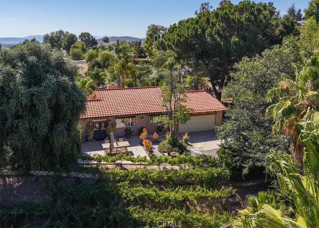 Horse & Wine Lover’s Dream in Temecula Wine Country!
Welcome to your private Mediterranean-style villa nestled in the heart of Temecula’s world-renowned wine country—where luxury meets country living. This beautifully enhanced equestrian estate offers the perfect blend of comfort, functionality, and charm.
The property features paid solar, a multi-stable barn with gated loading area, a mare barn, and a chicken coop/aviary for your feathered companions. A pasture with four separate holding and training areas provides excellent space for horses. The entire property is fully fenced and gated, with street frontage on three sides, and three separate entry points. The main entry has an electronic gate.
Inside, the gourmet chef’s kitchen is a true centerpiece, boasting double ovens, dual stove tops, and ample space for entertaining. The elegant formal dining area includes a climate-controlled, walk-in wine cellar with room for up to 500 bottles. The main floor primary suite features a rustic aesthetic, complemented by a spa-inspired bathroom for the ultimate retreat.
Enjoy resort-style amenities with your private indoor sauna, sparkling pool, and spa—perfect for unwinding after a long day.
Outdoors, pick from 10 varieties of fruit trees, tend to your own Cabernet and Merlot vineyard, explore the enchanting cactus garden, and admire the olive trees that dot the landscape.
Additional highlights include an attached two-car garage, plus a detached, oversized one-car garage with a workshop area—ideal for hobbies or storage.
All this, just minutes from top-rated schools, shopping, dining, freeways, and of course, world-class wineries.
Experience the best of wine country living—this is Temecula at its finest.