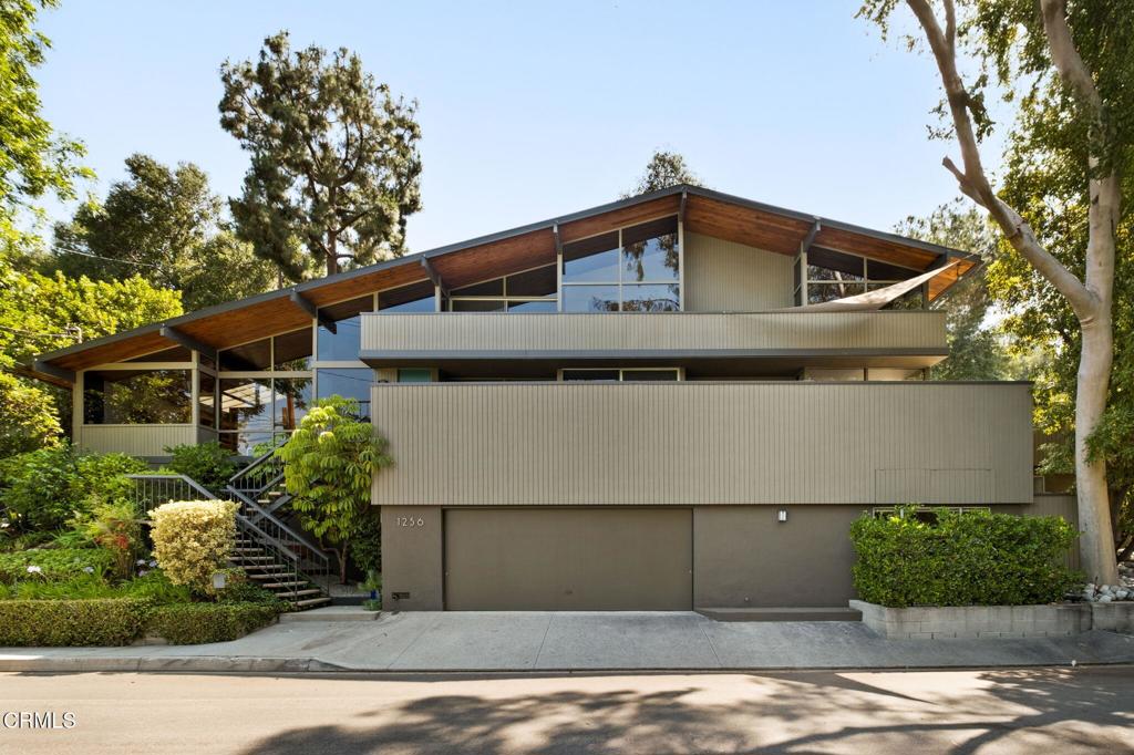 Nestled in Pasadena's most sought-after and exclusive neighborhood, this exceptional home--designed by notable architect John L. Pugsley--offers 4 bedrooms and 4.5 bathrooms, and is set behind the private gates of San Rafael's Brookmere Enclave. Situated with stunning views of Johnston Lake, this post and beam architectural gem features an open, airy floor plan with vaulted ceilings and an abundance of natural light pouring through floor-to-ceiling windows. The home showcases an exposed brick fireplace, creating a cozy focal point in the living space, while built-in shelves add both functionality and character. A wrap-around patio offers the perfect outdoor space for entertaining or relaxing, enjoying serene views of the lake and meadow. The first-floor bedroom and bathroom are ideal for guests or multi-generational living. Each of the bedrooms is a retreat, offering amazing views of the lake and meadow, all while maintaining complete privacy. This home is a rare find, combining architectural beauty with exceptional living space. Residents of this exclusive community enjoy access to a pool, lake, and park, enhancing the lifestyle of this private oasis.