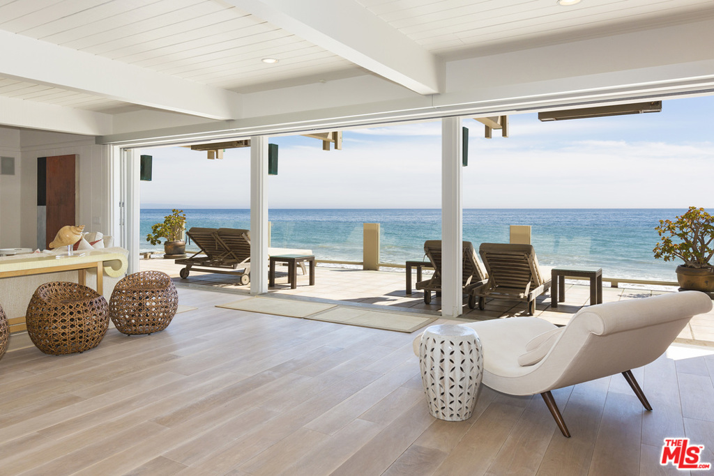 This Buff and Hensman mid-century modern single family residence located on the best and deepest part of La Costa beach features impressive post and beam accents with views from Santa Monica to Point Dume on 60 feet of beach frontage. The sound of a flowing fountain greets you as you pass through the expansive entry courtyard. Multiple doors open from the home creating an easy flow of movement from the courtyard to the great room, patio and beach beyond. The expansive great room spans the entire width of the property. The ocean side wall of disappearing glass creates an indoor/outdoor flow which enhances the entertaining space of the great room including a library alcove, kitchen, dining area, and several seating areas. The second level of the home features the master bedroom with a relaxation alcove, an ocean front guest bedroom, and a third bedroom furnished to sleep 6. A detached guest suite and bath completes the sleeping quarters. Bask in the serenity of one of Malibu's most desirable beaches in a home designed by two of the most celebrated architects in Los Angeles.