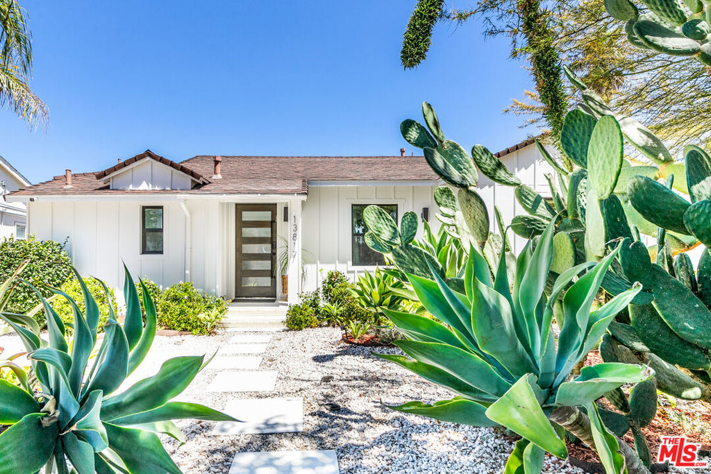 Step into this beautifully reimagined Valley Glen oasis, where comfort meets sophistication. Fully remodeled down to the studs and completed in 2023, this home combines timeless charm with today's most efficient technologies. From the moment you enter, you're welcomed by an expansive open-concept living area that flows effortlessly to a lush, private backyard your own personal paradise complete with a stunning oversized pool, mature trees, and a manicured lawn perfect for entertaining or serene relaxation. Thoughtfully designed for modern living, the main residence features 3 spacious bedrooms and 3 stylish bathrooms, complemented by a detached guest house with its own full bath and kitchenette ideal for visitors, extended family, or creative use. Bi-fold sliding glass doors create a seamless indoor/outdoor experience, bathing the home in natural light and inviting fresh breezes throughout. The chef's kitchen is open and elegant, flowing into a vaulted-ceiling living room adorned with skylights that bring a sense of airiness and warmth. The primary suite is a true sanctuary, tucked away for ultimate privacy. It features a spa-like bathroom with a soaking tub and oversized walk-in shower, as well as a generous walk-in closet. No detail was overlooked during the remodel: the home features all-new energy-efficient windows, updated electrical, a fast EV charger, a high-performance HVAC heat pump system, and a tankless water heater ensuring both luxury and sustainability. A gated front yard with an automatic gate enhances privacy and security, while the dreamy backyard evokes the feeling of a five-star resort. This home is more than just a place to live it's a lifestyle.