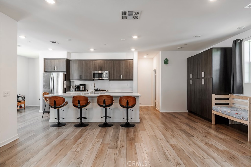 Welcome to The Preserve in Chino!
This stunning three-story corner residence blends modern style with everyday comfort, sharing only one common wall. The first floor features an extra-spacious 2 car garage with an EV charger already installed. On the second level, the open-concept design—upgraded with luxury vinyl plank flooring—seamlessly connects the main living area to a sleek kitchen and extends to a large private patio, perfect for entertaining or simply relaxing outdoors. Smart-home features are integrated throughout, offering convenience at your fingertips. Upstairs, you’ll find well-appointed bedrooms, including a primary suite designed for comfort and retreat. Buyer to assume the $85/month solar lease. As part of The Preserve’s resort-style community, residents enjoy exceptional amenities: sparkling pools and spas, a private theater, a 24-hour fitness center, tennis, pickleball and basketball courts, event spaces, BBQ areas, scenic parks, and playgrounds. Move-in ready and designed for today’s lifestyle, this home offers the perfect balance of luxury, convenience, and community.