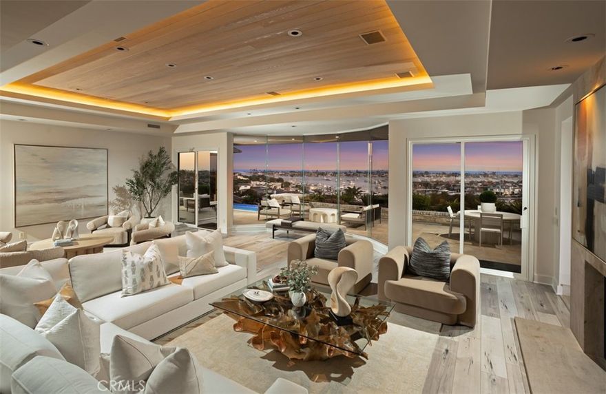 Perched on the front row of Corona del Mar’s coveted Irvine Terrace, 1535 Dolphin Terrace commands some of the most captivating views in all of Orange County. With an unmatched vantage point overlooking the mouth of the Newport Jetty, Harbor, Balboa Island, Catalina Island, and the sparkling Pacific and beyond, this property offers a front-row seat to the region’s most iconic sights—including nightly city lights, Fourth of July fireworks, and the world-famous Christmas Boat Parade. Ideally positioned across from the Newport Beach Country Club and moments from Fashion Island, Balboa Island, and the CDM Village, this single-level home offers both comfort and convenience in one of the coast’s most desirable neighborhoods. Inside, walls of glass frame the panoramic vistas from the great room, kitchen, and primary suite. The open-concept layout is perfect for entertaining, with a glass-enclosed dining area and expansive terrace for al fresco gatherings year-round. The resort-style backyard features an infinity-edge pool and elevated viewing terrace, ideal for watching boats glide through the channel by day and enjoying glowing sunsets and city lights by night. The primary suite includes a cozy fireplace and a spa-like bathroom with ocean-facing soaking tub, double vanities, and a walk-in shower. Whether you’re looking to move right in, renovate, or build your dream home, this is a rare opportunity to own one of CDM’s most iconic view properties in an unbeatable location.