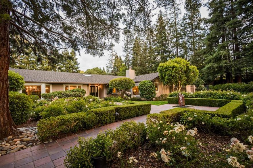 Very private retreat in the Las Lomitas school district.  Five bedroom, four bath ranch style house on flag lot.  Formal living room with fireplace and adjoining dining room.  Great room/kitchen with a breakfast area and wet bar.  Spacious master with two walk-in closets, fireplace, patio.  Detached three-car garage incorporates a cabana with kitchenette and full bath.  Landscaped grounds with arbor.  Pool and spa with portable safety fence.  Patio with outdoor entertainment system, including television.