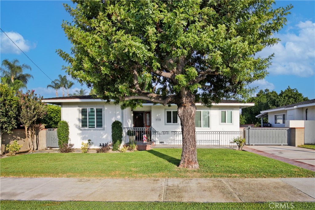 Charm and Tranquility! This inviting 2 bedroom, 2 bath home features a formal living room with fireplace, dining area, sunny kitchen, and a spacious primary bedroom with dual closets, high ceilings, retreat area and private bathroom with walk in shower. Enjoy outdoor living under the large covered patio overlooking a beautifully landscaped yard with grass, walkways, and mature greenery. A long gated driveway leads to the 2-car detached garage, providing plenty of parking and storage. Additional highlights include dual pane windows, central air and heat, individual laundry room, and solar panels for energy efficiency.