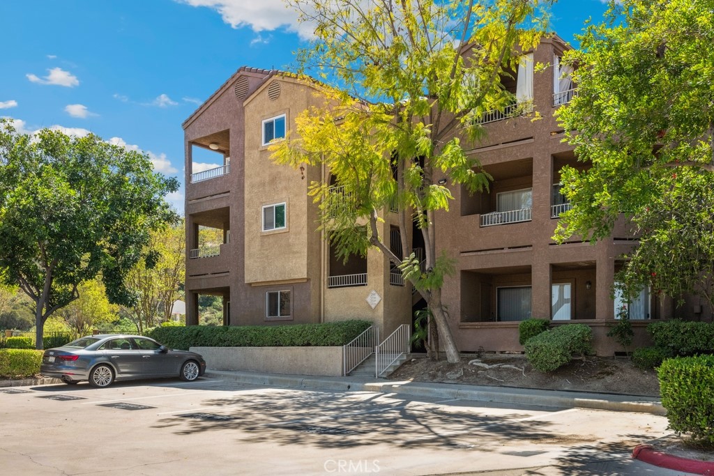 Move-in ready condo with stunning views in the desirable Sage Canyon community! Enjoy an open floorplan with a remodeled kitchen featuring white cabinetry, stainless steel appliances, Quartz countertops, and a seamless flow into the bright living and dining areas. Go out onto the private wrap-around balcony—a perfect spot to unwind and take in peaceful canyon and nature views. The spacious bedroom offers new carpet, abundant natural light, and a walk-in closet. Additional highlights include an in-unit laundry closet, a full-size bathroom with a linen cabinet, and updated finishes throughout. Community amenities include a clubhouse, gym, pool, spa, and basketball court. Conveniently located near shopping, dining, freeways, and entertainment—this home offers comfort, style, and convenience in one beautiful package!