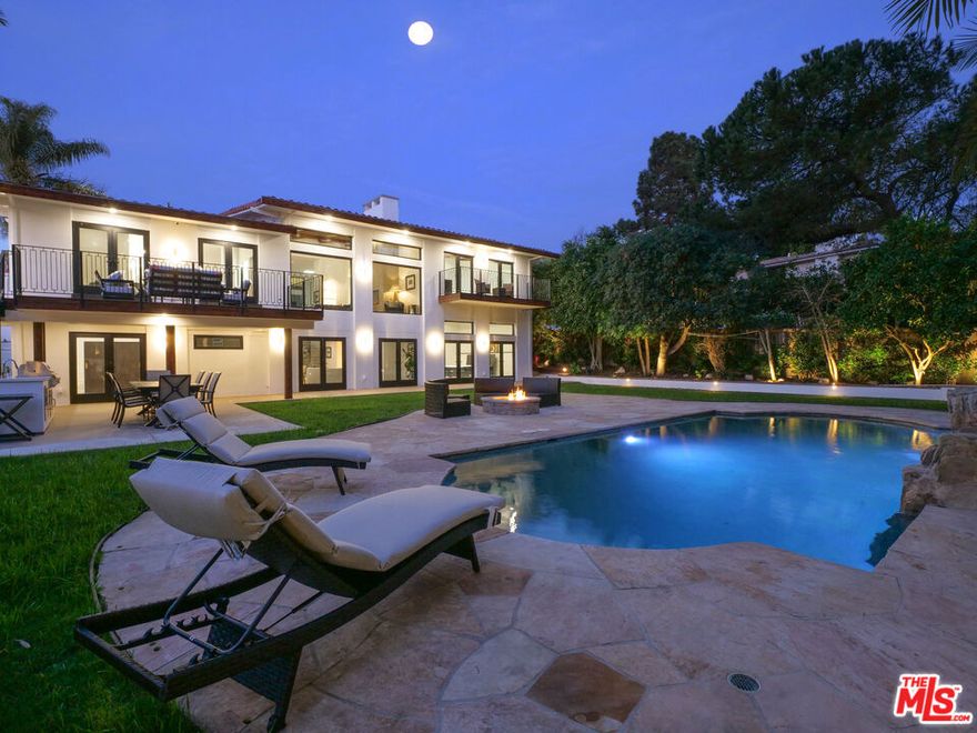 Tucked away in an ultra-private setting, this expansive 5,861 sq. ft. residence offers the perfect balance of luxury, serenity, and versatility. With 6 spacious bedrooms, 8 bathrooms, and 2 fully equipped kitchens, the home is ideal for both elegant entertaining and comfortable everyday living. The open-concept layout showcases soaring ceilings, 13 skylights, and seamless flow between the living, dining, and chef's kitchen. Two main-level en-suite bedrooms offer convenience and flexibility, while a private studio bedroom (Jr ADU) with its own entrance, kitchenette, and bathroom is perfect for guests, a home office, or creative space. The layout is exceptionally well-suited for multi-generational living, offering privacy and independence across multiple wings of the home. The resort-style backyard is designed for ultimate relaxation and entertainment, featuring a sparkling pool with cascading waterfall, outdoor kitchen and BBQ, fire pit, and sports bar area all surrounded by lush, secluded land scaping. Upstairs, one of two primary suites boasts its own balcony, a spa-inspired bath, and an oversized walk-in closet. Each additional bedroom includes an en-suite bathroom and direct outdoor access. With three balconies, abundant natural light, and thoughtful design throughout, this home offers a true retreat just moments from top-rated schools, the private beach club, and world-class golf and tennis. Move-in ready, with an option to purchase furnished. Discover the Palos Verdes lifestyle.
