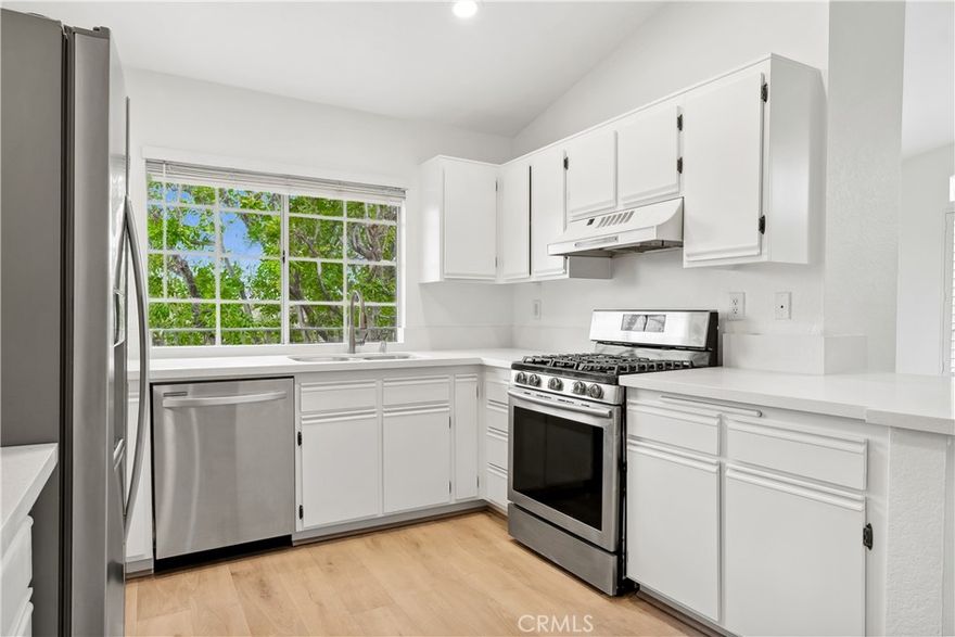 Discover this beautifully updated second-floor condo offering a perfect blend of comfort and style. This home features a remodeled kitchen, new quartz counter tops, fresh paint, and new carpeting. The open floor plan boasts high ceilings and a cozy fireplace in the living room, creating a warm and inviting space. Enjoy two spacious bedrooms and two bathrooms, with direct access to a private garage. Step out onto the large balcony to take in peaceful views of the greenbelt and pool—a perfect spot to relax and unwind. Located in a quiet community, this home offers lake access, making it an ideal retreat for those seeking tranquility. With its functional layout and modern updates, this condo is ready for you to move in and make it your own!