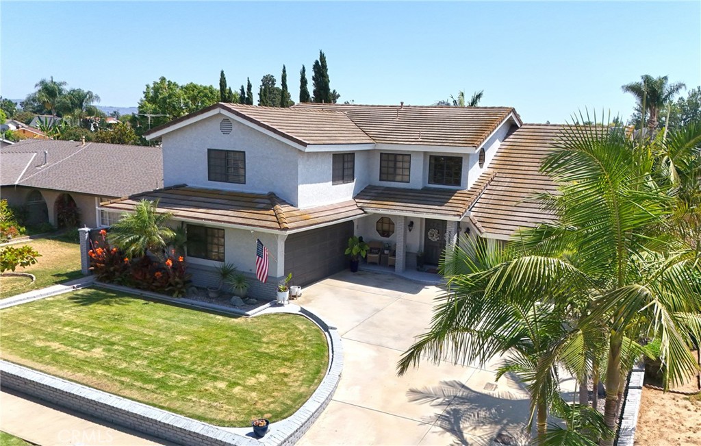 Experience Grand Living in Brea – Your Entertainer’s Dream Home! Welcome to this stunning custom-built Brea residence featuring 5 bedrooms, den and 4 bathrooms across 3,372 sq ft of thoughtfully designed living space, all on a spacious 7,284 sq ft lot with a sparkling pool and spa. Step through the elegant double doors into a dramatic entryway with soaring ceilings and a beautiful chandelier. The living room features a brick fireplace with gas logs, vaulted ceilings, rich hardwood floors, and custom window treatments. The open-concept design flows into the family room with recessed lighting, ideal for gatherings.The gourmet kitchen is a showstopper—quartz countertops, a large island with bar seating, farm sink, subway tile, and high-end stainless steel appliances including a 48-inch Z-Line six-burner stovetop with griddle and double oven, vent hood, built-in KitchenAid fridge, LG dishwasher, and butler’s pantry.Downstairs includes a full bedroom with recessed lighting and mirrored closet doors, plus two beautifully remodeled bathrooms. One bath offers a walk-in tile shower with mosaic inlay and seamless glass doors, the other features marble countertops and a tub/shower combo. A secondary laundry hookup is also available on this level. Upstairs, discover a cozy sitting room with custom lighting and an adjacent storage room with sink and counters. The private primary suite offers crown molding, a ceiling fan, French doors to a balcony, and a luxurious en-suite with Jacuzzi tub, tiled shower, dual vanities, and mirrored closets. Two additional upstairs bedrooms are spacious and well-appointed. A separate office/den with French doors also opens to the balcony. The multi-purpose laundry room includes solid oak cabinetry, utility sink, and a built-in desk—perfect for crafts or projects. Enjoy the backyard oasis with a fully remodeled diving pool and spa (2025), energy-efficient heater, and a 24x16 patio cover with recessed lighting and dual fans. The built-in BBQ island, vinyl fencing, and RV parking with hookups complete the outdoor amenities. This home offers energy efficiency with dual-pane windows, luxury vinyl flooring, dual HVAC units, a newer electrical panel, and an onwed and fully paid-off solar system (29 panels). Additional highlights: double-insulated interior walls, solid oak doors with Baldwin hardware, enclosed dog run, and no HOA or Mello Roos. Located in the coveted Golden Elementary School District (GATE program).