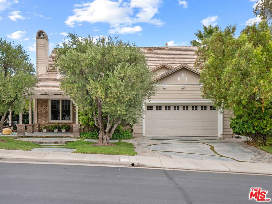 Breathtaking Gated Westridge Home with 4 Bedrooms, 2.5 Baths, Loft that is currently a billiards room, Downstairs Luxurious Primary Suite, a 3-Car Garage, and No Mello-Roos Taxes! This beautifully maintained home features exceptional curb appeal, an inviting front porch, and a spacious, light-filled floor plan. Step into the formal living room adorned with a charming stone fireplace and decorative glass accents, flowing into a generous formal dining area with built-in storage and a butler's pantry. The family room boasts soaring windows and opens to the chef's center island kitchen, complete with abundant counter space, built-in Sub-Zero refrigerator, upgraded commercial-grade range, stainless steel appliances, and ample cabinetry. The luxurious primary suite offers a spa-inspired en-suite bathroom with dual vanities, a large jetted soaking tub, an upgraded glass-enclosed walk-in shower, and a massive walk-in closet with custom organizers. A guest powder room and a well-equipped laundry room with utility sink and additional storage complete the first level. Upstairs, the grand staircase leads to a spacious loft currently used as a billiard's room and three additional bedrooms, two share a well-appointed Jack-and-Jill bathroom with dual sinks. Step outside to enjoy the lushly landscaped yard, featuring a large grassy area, covered pergola patio, and built-in cooking station which is perfect for entertaining. Located in a gated community of luxurious homes, residents enjoy access to resort-style amenities including a clubhouse, two swimming pools, tennis courts, sports courts and in close proximity to award-winning schools (Oak Hills Elementary, Rancho Pico Junior High, and West Ranch High School). Centrally located minutes from freeway, shopping and restaurants. Don't miss the opportunity to own this exceptional home in one of Westridge's most desirable communities!