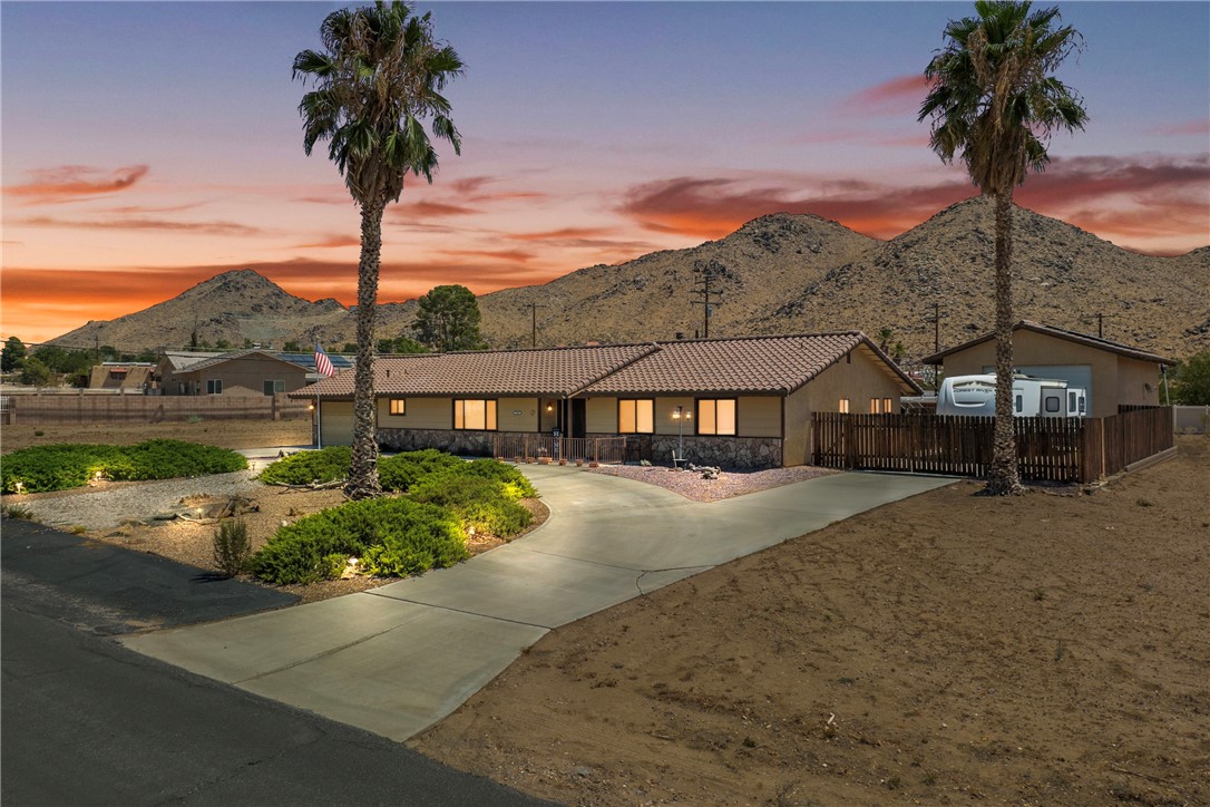 Beautiful Solar-Powered Home with Workshop & RV Parking in Prestigious Apple Valley Neighborhood! Welcome to this absolutely stunning home located in a quiet, highly sought-after neighborhood of Apple Valley. Designed for comfort, style, and functionality, this property offers a thoughtful layout and fantastic outdoor amenities—all with buyer to assume solar for energy savings. Inside, you’ll find a large formal dining room and a warm, inviting family room with a wood-burning stove, open to the kitchen and breakfast counter and sitting area —perfect for gatherings. The home features three generously sized bedrooms, including a primary suite with its own en-suite bathroom, plus ceiling fans in every room for year-round comfort. The property’s terrific curb appeal is highlighted by a low-maintenance front yard, a U-shaped driveway for easy access, and an additional driveway leading to the 2-car garage. In the backyard, enjoy an amazing workshop plus a fenced-off RV storage area, offering plenty of space for hobbies, tools, and toys. A covered patio with direct indoor access is ideal for relaxing or entertaining, with ample room to design your own private backyard oasis. Conveniently located close to hospitals, schools, and shopping, this home blends a prime location with desirable features—inside and out. Don’t miss your chance to see this exceptional property—schedule your private showing today! ***Buyer to Assume Solar**