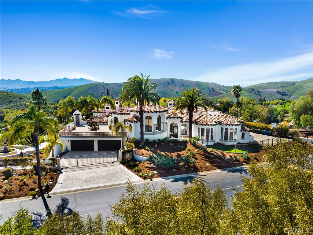 This breathtaking property is a true masterpiece of luxury and design! A gated Spanish contemporary compound in the exclusive North Ranch Country Club Estates, it combines traditional elegance with modern sophistication. Reimagined by designer Robb Friedman, the home offers unparalleled craftsmanship, panoramic mountain views, and lavish amenities.
Key Features:
• Interior Highlights:
• Gourmet Kitchen: Custom cabinetry, dual Viking refrigerators, 66-inch Viking Tuscany range, two dishwashers, and a butler’s pantry.
• Entertainment: State-of-the-art theater, game room, and dual powder rooms.
• Luxurious Primary Suite: Includes a sitting room, cement fireplace, European white oak/glass walk-in closet, a spa-like bathroom with a cement soaking tub, custom shower, and a massage/yoga room.
• High-End Finishes: Moroccan lime-wash accent walls, custom European wide-plank white oak flooring, and designer bathrooms.
• Resort-Style Grounds:
• Two pools: One with a waterfall and pool house, the other with waterslides and a grotto.
• Multiple outdoor entertaining spaces: Two BBQ areas, a gazebo, and sprawling lawns.
• Scenic exploration: Custom rock staircases spanning 3+ acres of grounds with jetliner views.
• Additional Luxuries:
• Elevator and dumbwaiter for convenience.
• Detached guest house and pool house.
• Oversized 4-car garage with storage.
• Oversized Solar Power System.
Every detail of this estate is meticulously curated for beauty and functionality, making it a rare gem in the luxury market.