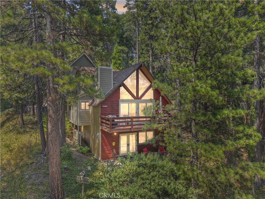 Possibly the most unique home and a true gem in Arrowhead Woods with "Lake Rights" ~ Your parking and garage are accessed by the asphalted access road ~ The owners have already done everything you would want to do, and much, much more! Completely remodeled, added the garage, a separate workshop with approximately 800 sq. ft. of storage area that stretches above the garage and workshop with an artist's studio as well ~ A covered walkway between the garage and workshop leads you to the front door ~ Inside is where you will fall in love ~ The main level has soaring tongue & groove ceilings, a wood burning fireplace, wood grain laminate flooring throughout, the remodeled kitchen with Alder cabinets, granite countertops and a tile backsplash with one of the most unique features ever seen ~ In the backsplash, the owner included two 50 million year old Eocene Age Green River Priscacarca Liops fossil fish tiles and a custom cutting board for the sink with additional fossils inlaid in the wood ~ On this level you also have the master bedroom with the same wood grain laminate floors, tile walls, French doors to the covered porch, and a remodeled bathroom with custom tile and an artist signed blown glass sink ~ The top floor has two bedrooms, a loft and a remodeled bathroom ~ The bottom level has your family room with a freestanding gas fireplace, custom cabinetry throughout, desk area with a built in Murphy bed, French doors to the rear patio, and a custom remodeled bathroom ~ The whole house has fresh exterior paint and stain ~ Natural gas, propane and electric generator that is hooked up to the electric system to power most of the home, garage and workshop ~ Add in the tankless water heater and dual pane windows and you get a completely turn key property that features so many unique touches that you will be in love!