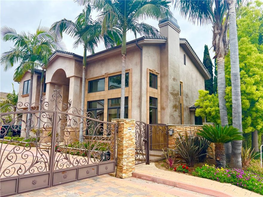 Welcome to this beautiful Tuscan-inspired residence, offering over 4,000 square feet of meticulously designed living space adorned with premium finishes throughout. Perfectly balancing elegance and comfort, the home seamlessly blends indoor and outdoor living within a secure, gated enclave.

The timeless interior features a traditional layout highlighted by high ceilings, travertine and rich hardwood flooring, and a dramatic spiral staircase with wrought iron detailing. At the heart of the home lies a gourmet kitchen, complete with luxurious granite countertops, top-of-the-line appliances—including a Viking 6-burner stove, double oven, built-in microwave, dishwasher, and oversized refrigerator—and a spacious walk-in pantry.

Retreat to the expansive primary master suite, featuring a cozy fireplace, generous walk-in closets, and a spa-inspired bathroom with a jacuzzi tub. Two additional bedrooms are conveniently located on the second level along with two bedrooms on the main level, one of which has its own private entrance—ideal for in-laws, guests, an au pair, and more. Four bedrooms and a casitas with separate access.

Additional highlights include a spacious outdoor garden and backyard, a downstairs office, an electric car charging station in the 2-car garage, and refined architectural details throughout.

Centrally located on the east side of costa mesa just moments from the scenic Newport Back Bay Trails, world-class shopping and dining at Fashion Island and South Coast Plaza, the vibrant 17th Street corridor, and the beautiful beaches of Newport and Corona del Mar. Zoned for some of the area’s top-rated schools, including CDM, Newport Harbor High School, Ensign Intermediate, and Kaiser Elementary.