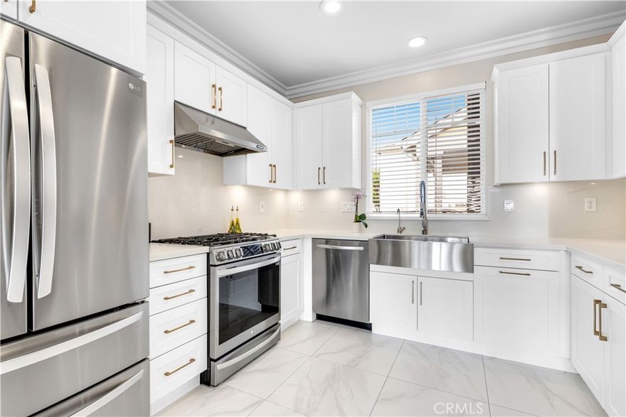 This modern 3-bedroom Detached Residence features a large private wrap-around yard, custom cabinets in the fully renovated kitchen, impeccably crafted fireplace surround & mantle in the living room, and renovated bathrooms. All living space is located on the main level, in what is the 2nd largest model in this neighborhood, creating a seamless flow from the kitchen, living, and dining areas - to the spacious backyard. The fully remodeled kitchen features bright white custom cabinetry with sophisticated drawer and cabinet hardware, quartz countertops and backsplash, along with all stainless steel appliances, range hood and an extra-large single-basin sink. Upstairs you’ll find 3 bedrooms, a laundry room and 2 remodeled bathrooms, along with a loft featuring two built-in desks, providing a ready-made home office or study space. The spacious master bedroom includes a walk-in closet with custom fit dresser drawers, and a remodeled bathroom that matches the secondary upstairs bathroom which also features dual vanities. The backyard has plenty of seating and space to BBQ, play and entertain, with no neighbors behind. Enjoy the unbeatable location—walking distance to award-winning schools, local dining, shopping, community pools, parks, and playgrounds. Home features include smart thermostat, EV-Charger, and filtration water system at kitchen sink. Additional home improvements include a whole house repipe, plantation shutters throughout most of the home, ceramic tile flooring downstairs and engineered wood floor upstairs. Experience the friendly charm and everyday convenience that make Ladera Ranch one of Orange County’s most sought-after communities. HOA Fees include: front of home landscaping maintenance and high speed internet.