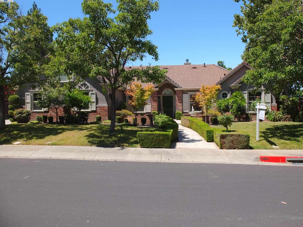 Welcome to this beautifully maintained semi-custom home located in Walnut Glen Estates, one of Pleasanton’s most desirable neighborhoods and within the acclaimed Mohr Elementary School District. This single-story residence features 5 bedrooms, 4 bathrooms, and a 3-car garage, offering over 3,170 sq. ft. of well-designed living space on a 1/3-acre lot. A grand entry with 14-foot ceilings opens to a bright, open-concept layout. The formal living & dining rooms showcase large windows that provide abundant natural light and sweeping views of the landscaped backyard. The gourmet kitchen includes high-end stainless steel appliances, a quartz island, walk-in pantry, and breakfast nook, flowing into the family room with a fireplace and direct access to the serene backyard-complete with a water fountain & a huge pergola, perfect for entertaining. The primary suite serves as a private retreat, complete with a luxurious en-suite bathroom featuring a jetted soaking tub & ample closet space. A secondary en-suite includes a private bath with a walk-in tub & heated floors, ideal for guests or multigeneration living. A 5th bedroom near the foyer, with built-ins, and plantation shutters, makes an excellent home office. A perfect balance of luxury, comfort, and location - this home is a must-see.