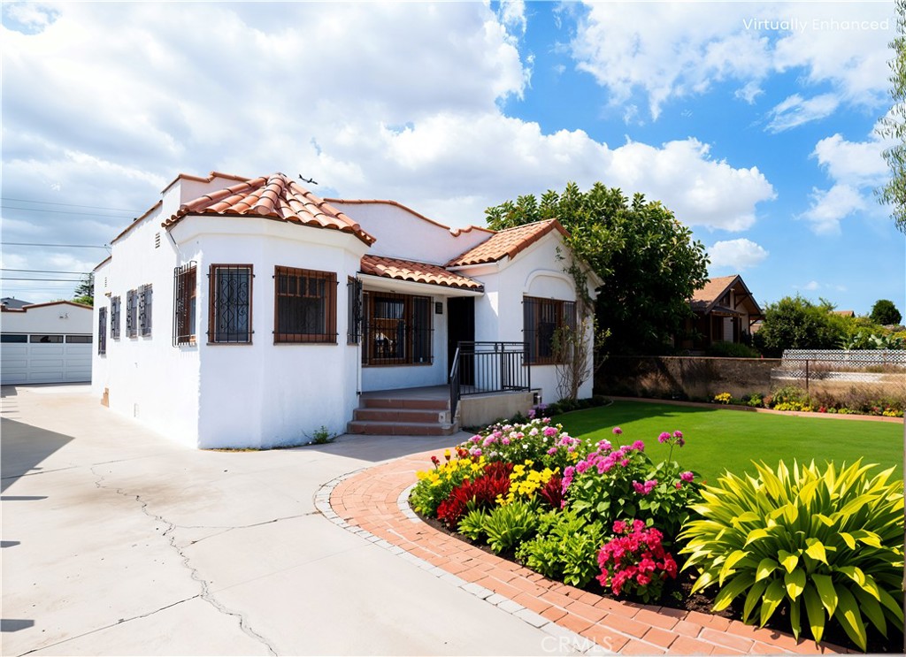 Charming 4-bedroom, 2-bath Spanish-style home with timeless character and great potential in Los Angeles. The inviting living room features a cozy fireplace and opens to the formal dining room with built-in cabinetry. The kitchen offers granite countertops, ample cabinet storage, and generous workspace, and opens to a breakfast nook on one side and an interior laundry room on the other. The primary suite includes its own full bath, while the hallway provides additional built-in storage, and the second bathroom features a convenient vanity station. Situated on a fully gated lot, the property includes spacious front and back yards, offering plenty of room for entertaining, gardening, or even creating your own custom retreat. A long driveway leads to a detached two-car garage, providing abundant parking. Conveniently located near parks, shopping, dining, and grocery stores, as well as Inglewood’s vibrant entertainment district with The Forum, SoFi Stadium, YouTube Theater, Hollywood Park Casino & Shopping Center, and the Intuit Dome. Excellent connectivity to public transportation and major freeways (I-110, I-105, and I-405) places LAX, local beaches, Exposition Park, USC, Downtown LA, Mercado La Paloma, and more all within easy reach. This well-situated home is full of charm and opportunity, ready for your personal touches.