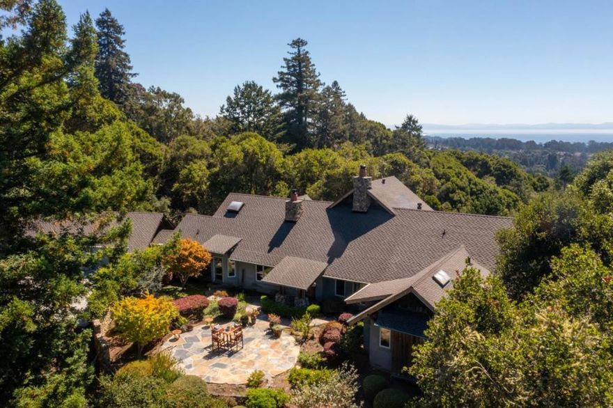 Privacy, nature and breathtaking views abound at this remarkable property. Located near the end of Quail Run Rd, the 4+ acre parcel offers quiet and tranquility. Surrounded by oak and redwood trees, the home feels away from it all, with almost daily sightings of wildlife. Yet it is only minutes from Aptos Village & the conveniences it offers. Thacher & Thompson Architects designed this custom home with the landscape in mind, featuring spectacular ocean views from nearly every room. With mostly trees in the foreground, the natural view is truly exceptional. The home itself feels warm and inviting, though refined at the same time. The beautifully designed courtyard & dramatic 2 story entry set the tone for the home. Spacious rooms, high quality materials, and expansive windows are found throughout. The well thought out floorplan features a library, family room, two decks, and two ensuite bedrooms on the main level. Upstairs the almost 900 sf primary suite boasts a private sunroom, spacious bathroom with 2 closets, an oversized tub & shower, all highlighting the ocean view.  Additional amenities include a generator, finished 3 car garage, and plenty of space for guest parking. This home has been treasured by two families since it was built and is ready to become your sanctuary.