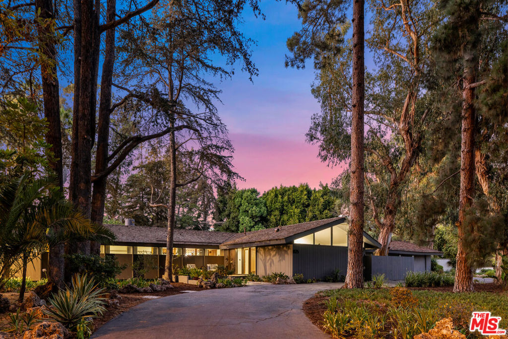 One of Santa Monica's finest examples of California mid-century modern ranch style. Owned by the same family for over 50 years, this unique and versatile estate presents a once-in-a-lifetime opportunity to recast an architectural gem with 21st century vision and design. Located on Santa Monica's most exclusive street, the tranquil cul-de-sac setting enveloped by towering trees provides the backdrop for a sprawling single-story on a large flat lot spanning over 33,000 square feet. Designed by architect William Carlton Jarrett and completed in 1955, with a primary wing addition by noted architect Paul Sterling Hoag, the 6-bedroom, 4 and half bathroom home is a mid-century modern symphony: sun-lit interiors, wide overhanging eaves, high-beamed ceilings, floor-to-ceiling windows, wood paneling, stone and marble fireplaces, an atrium and more. Indoor/outdoor living is celebrated throughout, while your very own slice of nature rests just beyond with a large pool, deck, and forested landscaping all around you. This pedigree offering also includes multiple outside entertainment spaces and a 3-car garage. This is an uncommon oasis in the city - surrounded by nature, nestled between the Pacific Ocean and the world-renowned Riviera Country Club, yet only minutes from Montana Avenue. Reimagine its next evolution!