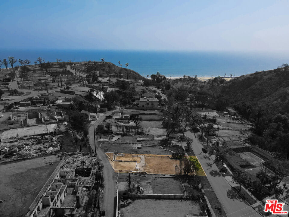 Exceptional lot on the bluff side of Radcliffe Ave, offering stunning ocean views from the second story. This street-to-street lot has been professionally cleared and is ready for immediate construction, with fast-track permitting in place allowing for up to 10% additional square footage beyond the original 2,589 sq. ft. floorplan. A rare alley access at the rear of the property provides private parking and introduces exciting potential for a fully separate ADU perfect for guest use or income generation. With the EPA Phase 1 assessment already completed, this is a unique opportunity to build your dream home in an unbeatable location just moments from Palisades Village, the Bluffs, award-winning schools, premier shopping, fine dining, parks, beaches, and all the energy of the Palisades' continued revitalization.