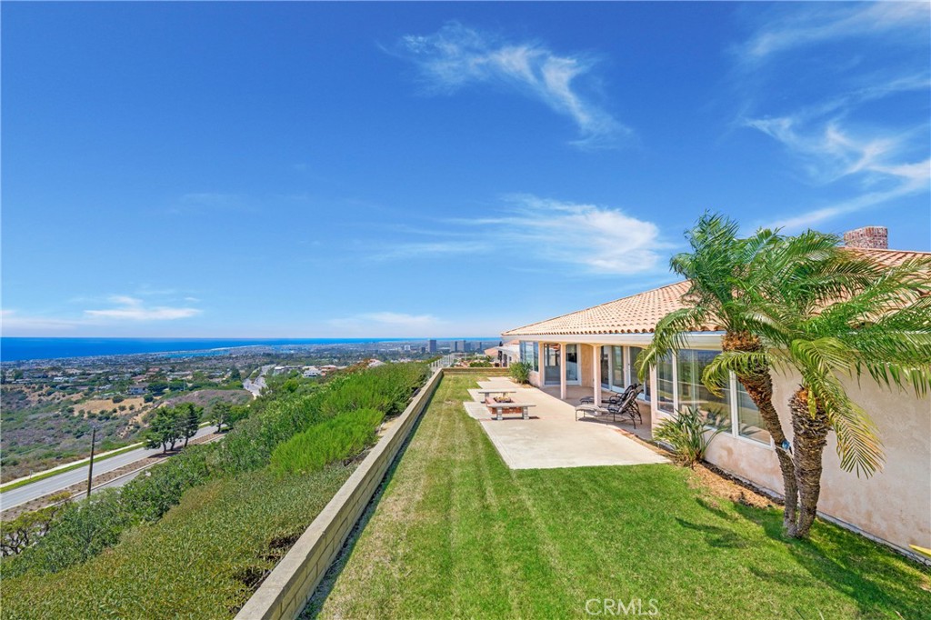 Stunning Single-Level Home with Panoramic Views in Coveted Spyglass Hill Welcome to this exceptional lease opportunity in the highly sought-after community of Spyglass Hill in Corona Del Mar. Perched on an elevated lot along a single-loaded street, this beautifully appointed single-level home offers breathtaking panoramic views stretching from the Newport Coastline to Balboa Island. Spanning approximately 2760 sq ft, the home features 4 spacious bedrooms and 2.5 bathrooms, including a guest powder room highlighted by elegant Art Deco-inspired finishes. The expansive formal living and dining rooms are centered around a stunning travertine stone fireplace, with French doors opening to a private patio complete with a firepit—perfect for enjoying the ocean and canyon vistas. A sun-drenched kitchen and family dining area boast a central island with barstool seating, creating a welcoming space for everyday living and entertaining. The family/media room is outfitted with a striking stacked stone fireplace, floating granite shelves, a built-in entertainment unit, and a wet bar, blending comfort with sophisticated style. The primary suite features private patio access and direct views over Balboa Island, offering a serene retreat. Additional highlights include: 3-car detached garage plus off-street parking for 3 more vehicles, Located in an established, prestigious neighborhood with quality homes, Spacious rear and side patios ideal for entertaining and enjoying Southern California sunsets This rare lease combines timeless design with unbeatable views in one of Corona Del Mar’s most desirable enclaves.